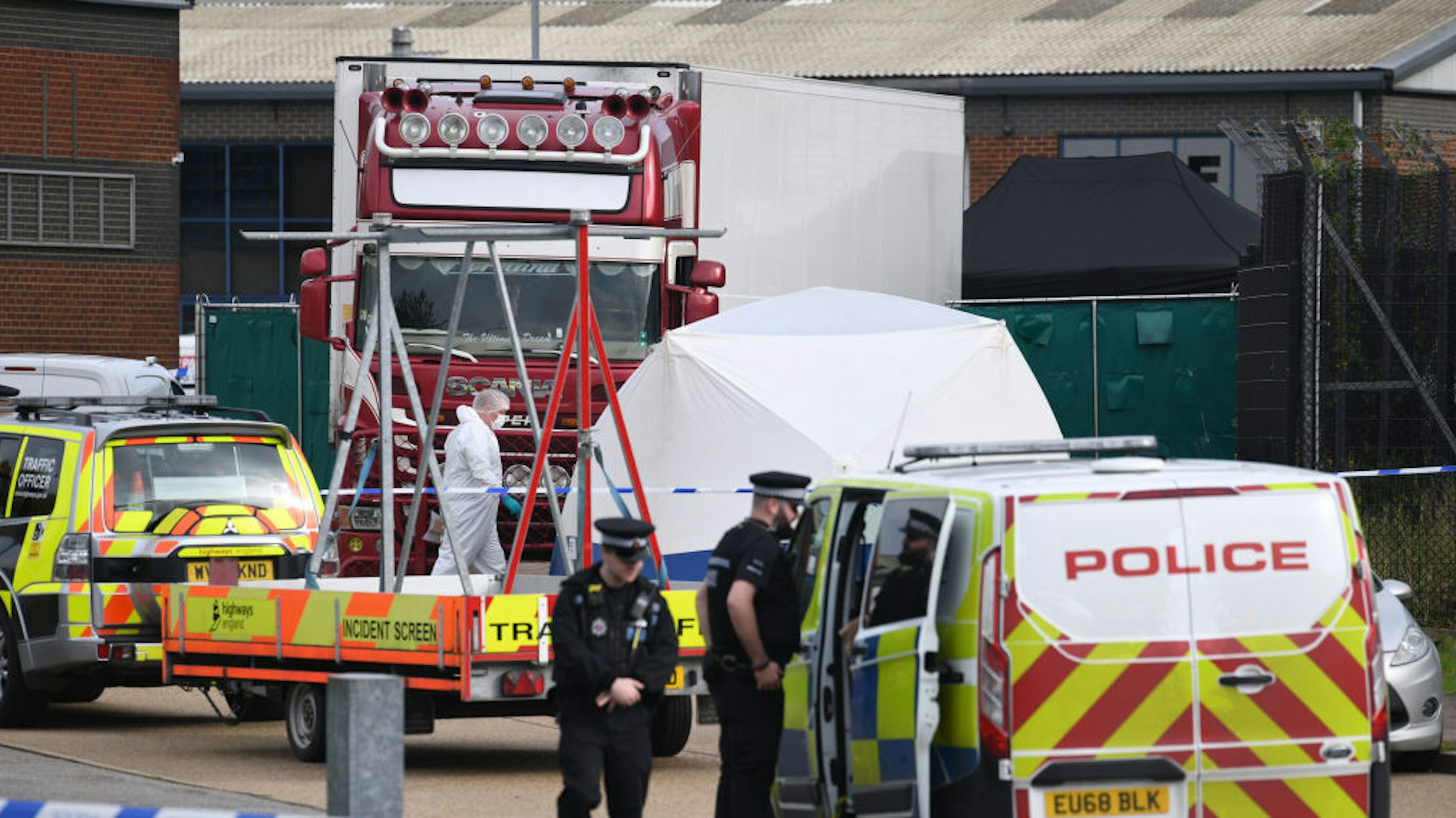 Police and forensic officers inspect the site where 39 bodies were discovered in the back of a lorry on October 23, 2019 in Thurrock, England. The lorry was discovered early Wednesday morning in Waterglade Industrial Park on Eastern Avenue in the town of Grays. Authorities said they believed the lorry originated in Bulgaria and entered the country at Holyhead on October 19. The suspected driver was arrested in connection with the investigation. (Photo by Leon Neal/Getty Images)