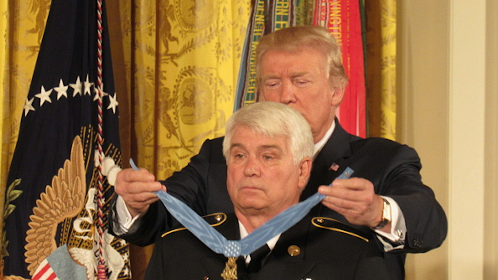 U.S. President Donald Trump presents the Medal of Honor to former Army Specialist James McCloughan (L) of South Haven, Michigan, during an East Room ceremony at the White House July 31, 2017 in Washington, DC. McCloughan is awarded with the medal for his heroic acts as a combat medic during the Vietnam War. .