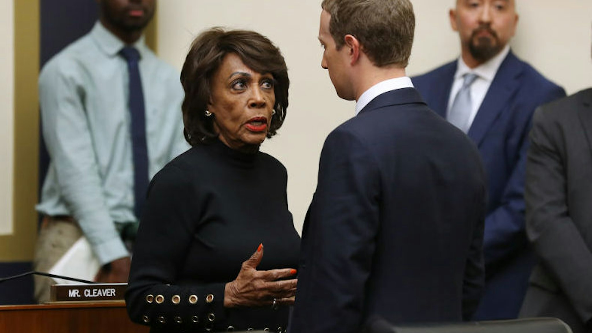 WASHINGTON, DC - OCTOBER 23: House Financial Services Committee Chair Maxine Waters (D-CA) talks with Facebook co-founder and CEO Mark Zuckerberg after he testified to the committee for six hours in the Rayburn House Office Building on Capitol Hill October 23, 2019 in Washington, DC. Zuckerberg testified about Facebook's proposed cryptocurrency Libra, how his company will handle false and misleading information by political leaders during the 2020 campaign and how it handles its users‚Äô data and privacy.
