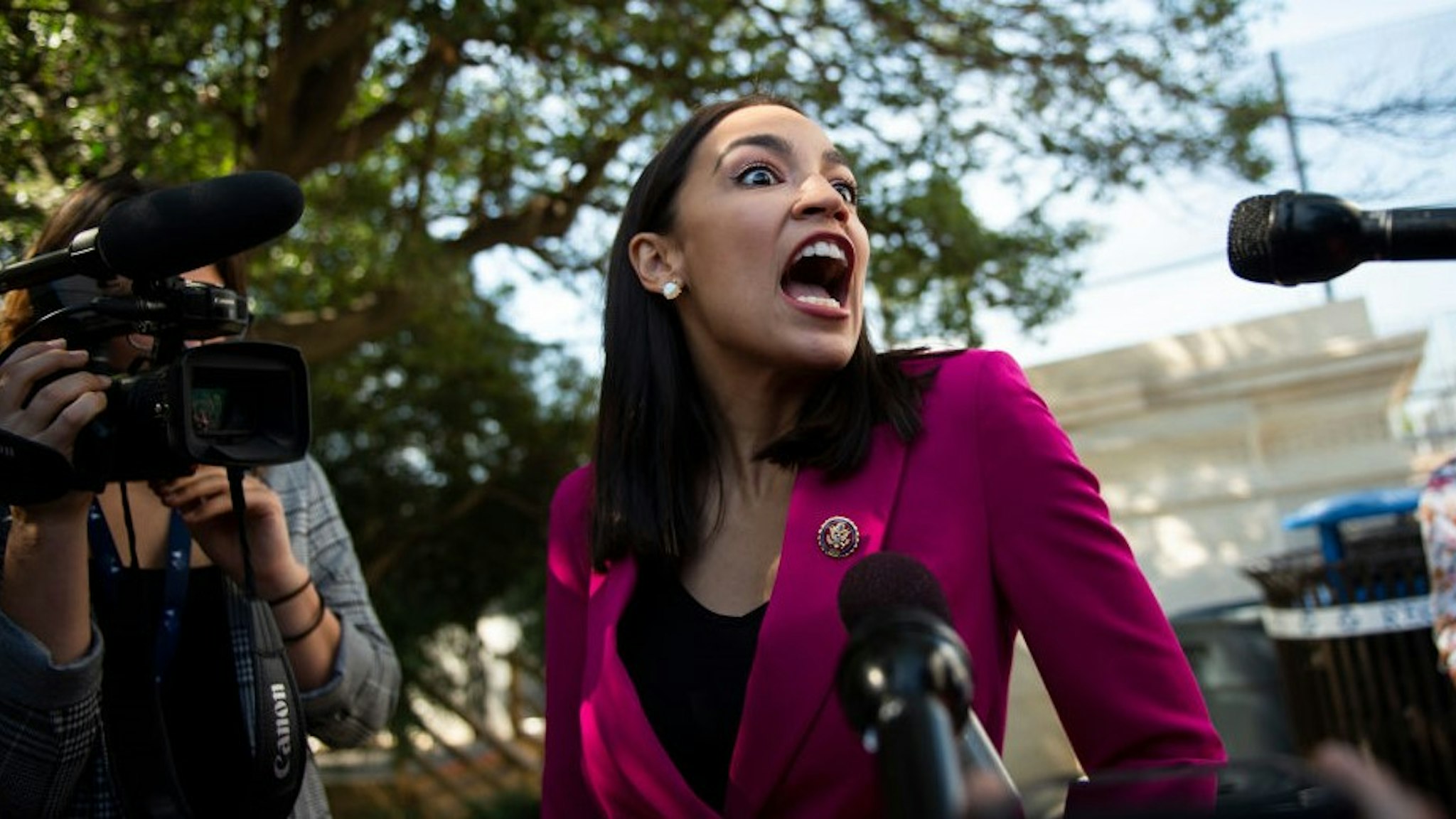 Rep. Alexandria Ocasio-Cortez, D-N.Y., stops to speak with reporters outside of the Capitol after the final votes of the week on Friday, Sept. 27, 2019.