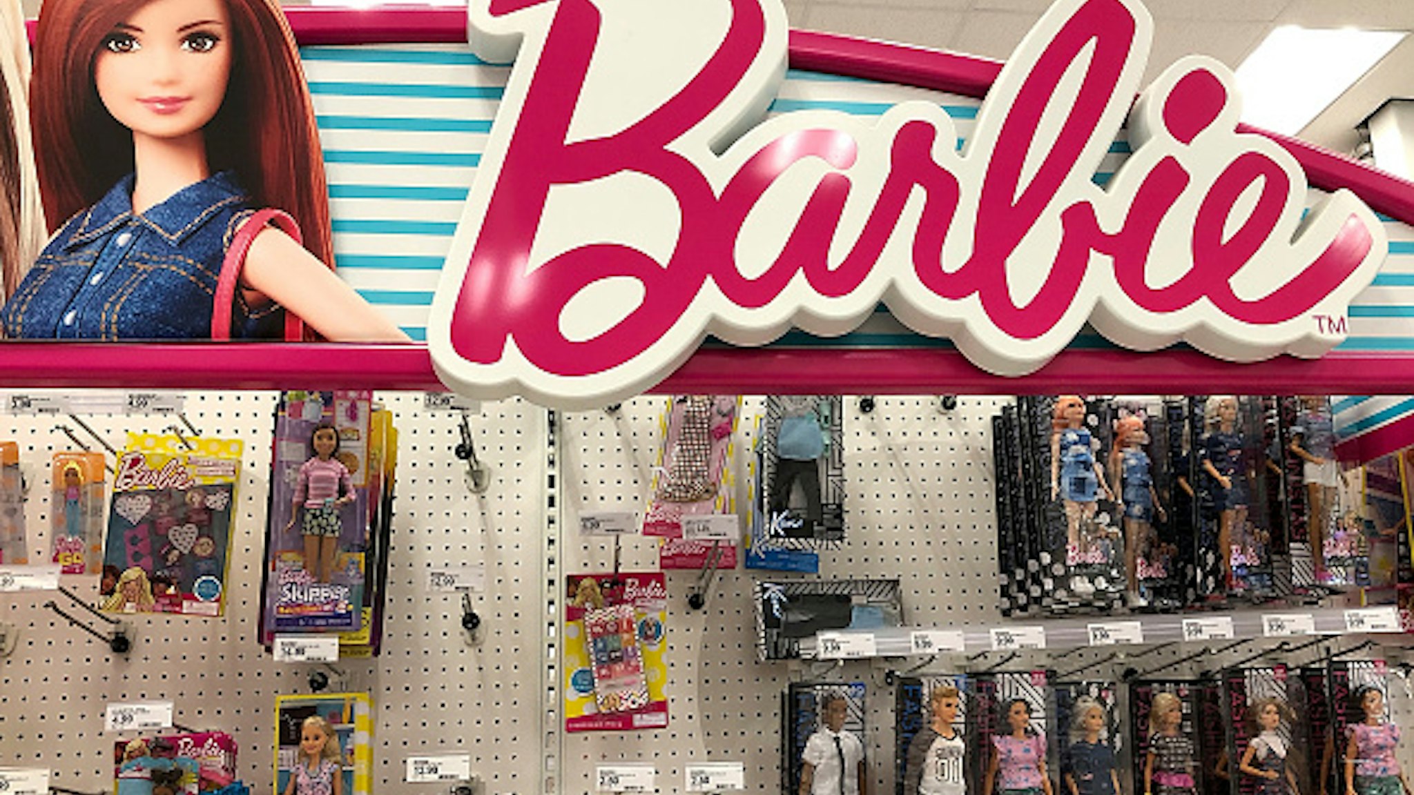SAN RAFAEL, CA - JULY 25: Barbie dolls, made by Mattel, are displayed on a shelf at a Target store on July 25, 2018 in San Rafael, California. Toy maker Mattel announced plans to cut 2,200 non-manufacturing jobs after reporting a $240.9 million loss in its second quarter earnings.