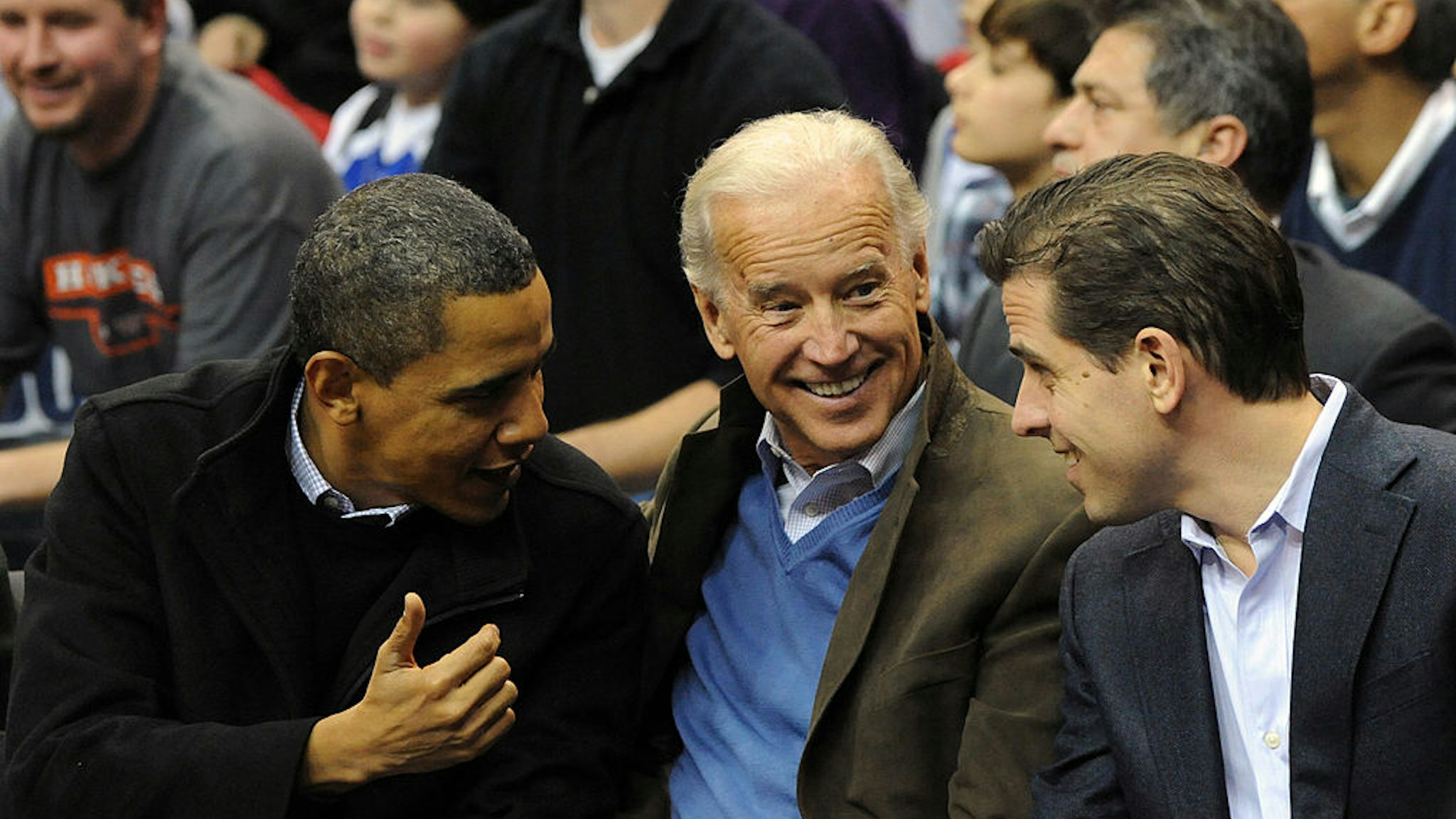 U.S. President Barack Obama (L) greets Vice President Joe Biden (C) and his son Hunter Biden as they attend the game between the Duke Blue Devils and Georgetown Hoyas on January 30, 2010 at the Verizon Center in Washington, DC. (Photo by Alexis C. Glenn-Pool/Getty Images