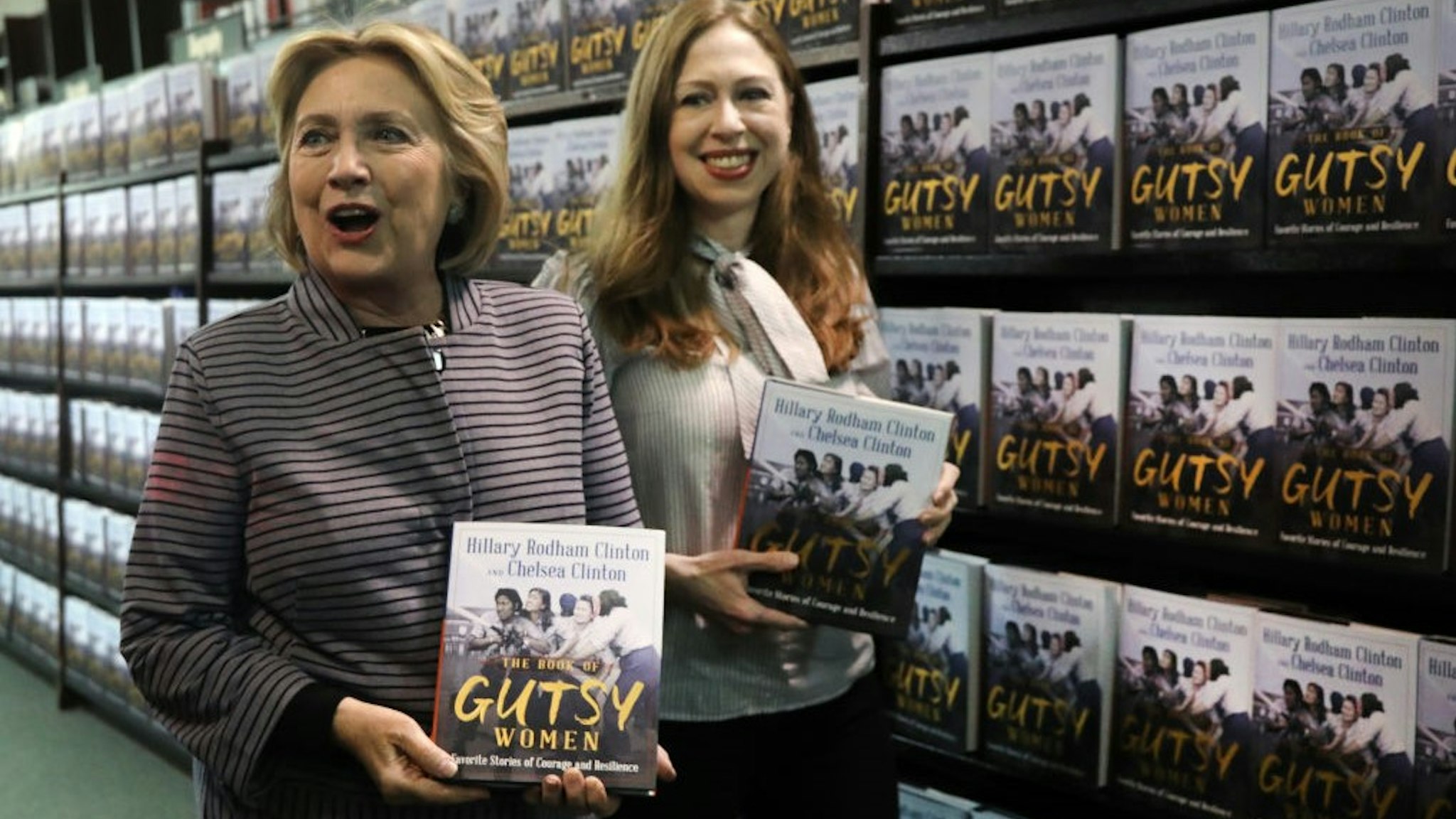 Chelsea and Hillary Clinton pose with their new book "The Book of Gutsy Women" on October 03, 2019 in New York City. The new book by mother and daughter co-authors celebrates women in history, many of whom have been overlooked, that have stood up to adversity. (Photo by Spencer Platt/Getty Images)