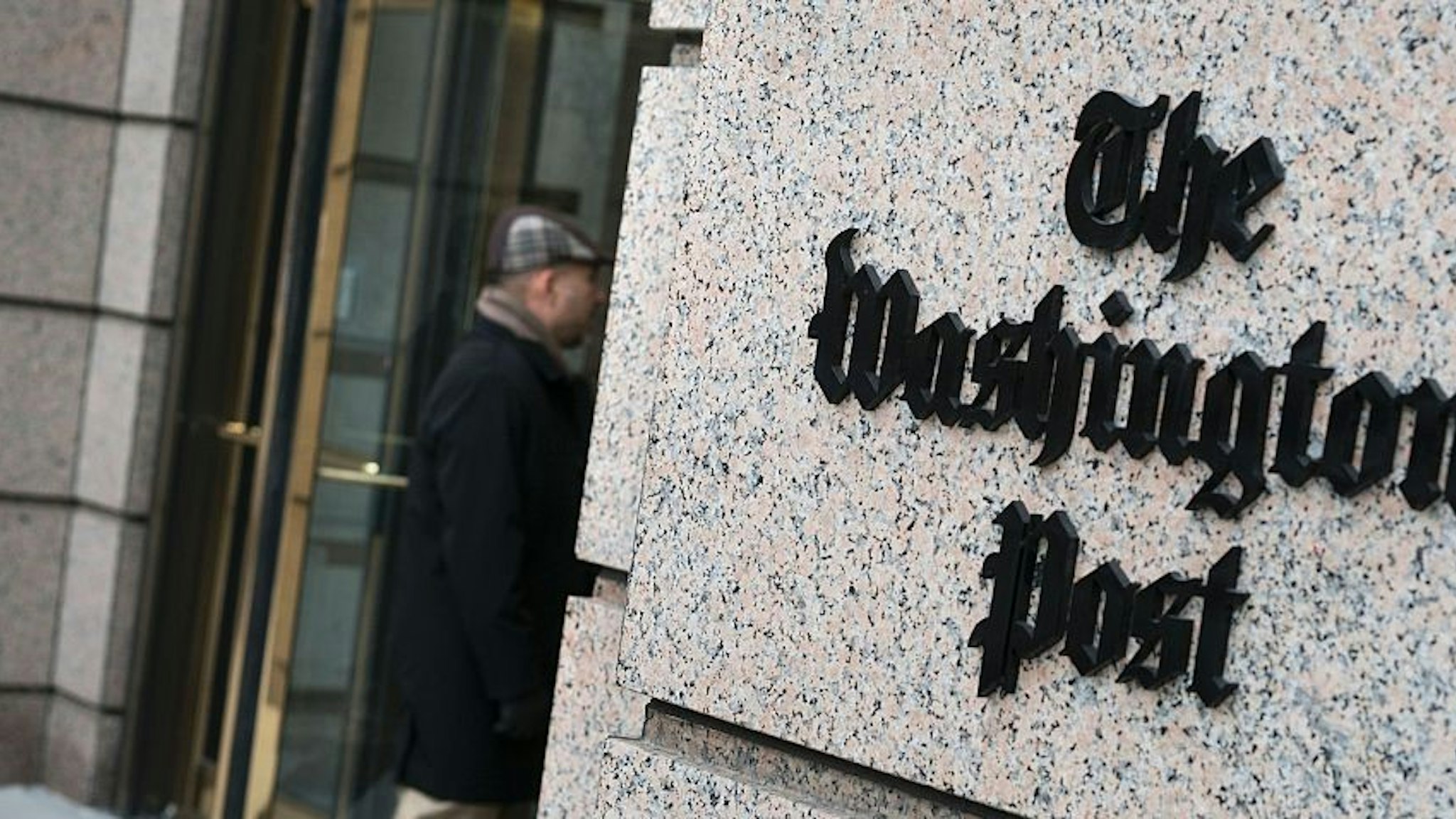 A man walks into the Washington Post's new building March 3, 2016 in Washington, DC. A view of the Washington Post's new building March 3, 2016 in Washington, DC. / AFP / Brendan Smialowski (Photo credit should read BRENDAN SMIALOWSKI/AFP/Getty Images)