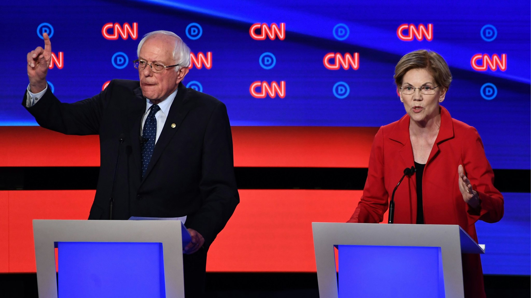 Democratic presidential hopeful US Senator from Massachusetts Elizabeth Warren (R) speaks next to US senator from Vermont Bernie Sanders during the first round of the second Democratic primary debate of the 2020 presidential campaign season hosted by CNN at the Fox Theatre in Detroit, Michigan on July 30, 2019.