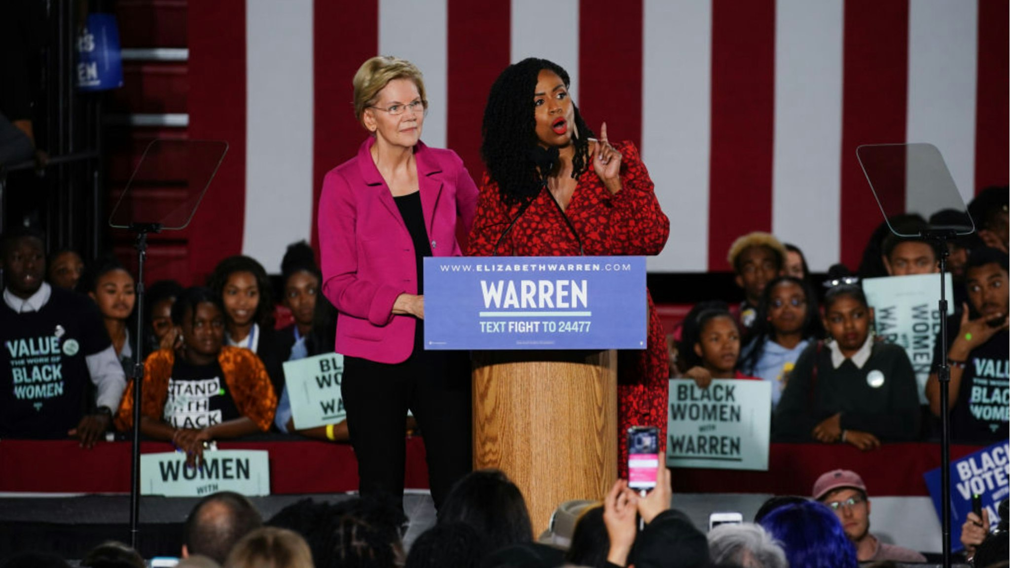 Democratic presidential candidate Sen. Elizabeth Warren (D-MA), stands with U.S. Rep. Ayanna Pressley (D-MA) as she addresses a group of protesters during a campaign event at Clark Atlanta University on November 21, 2019 in Atlanta, Georgia.