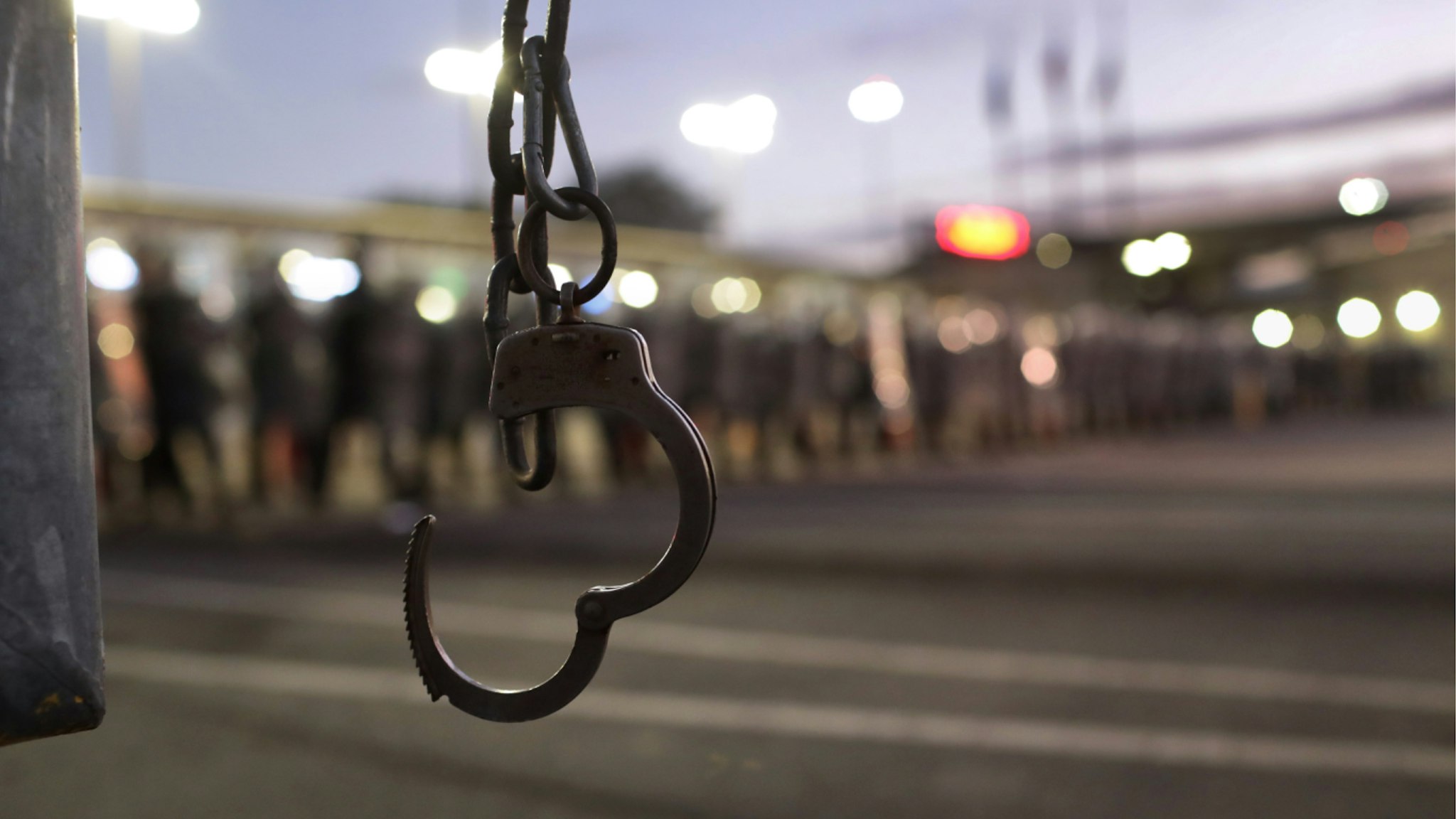 A handcuff attached to a fence is seen as U.S. Customs and Border Protection (CBP) officers block the Otay Mesa port of entry from Mexico into the United States early on December 1, 2018 as seen from Tijuana, Mexico.