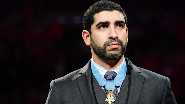 Medal of Honor recipient retired U.S. Army Capt. Florent 'Flo' Groberg takes part in a ceremonial puck drop before the start of an NHL game between the New Jersey Devils and Washington Capitals at Verizon Center on March 2, 2017 in Washington, DC.