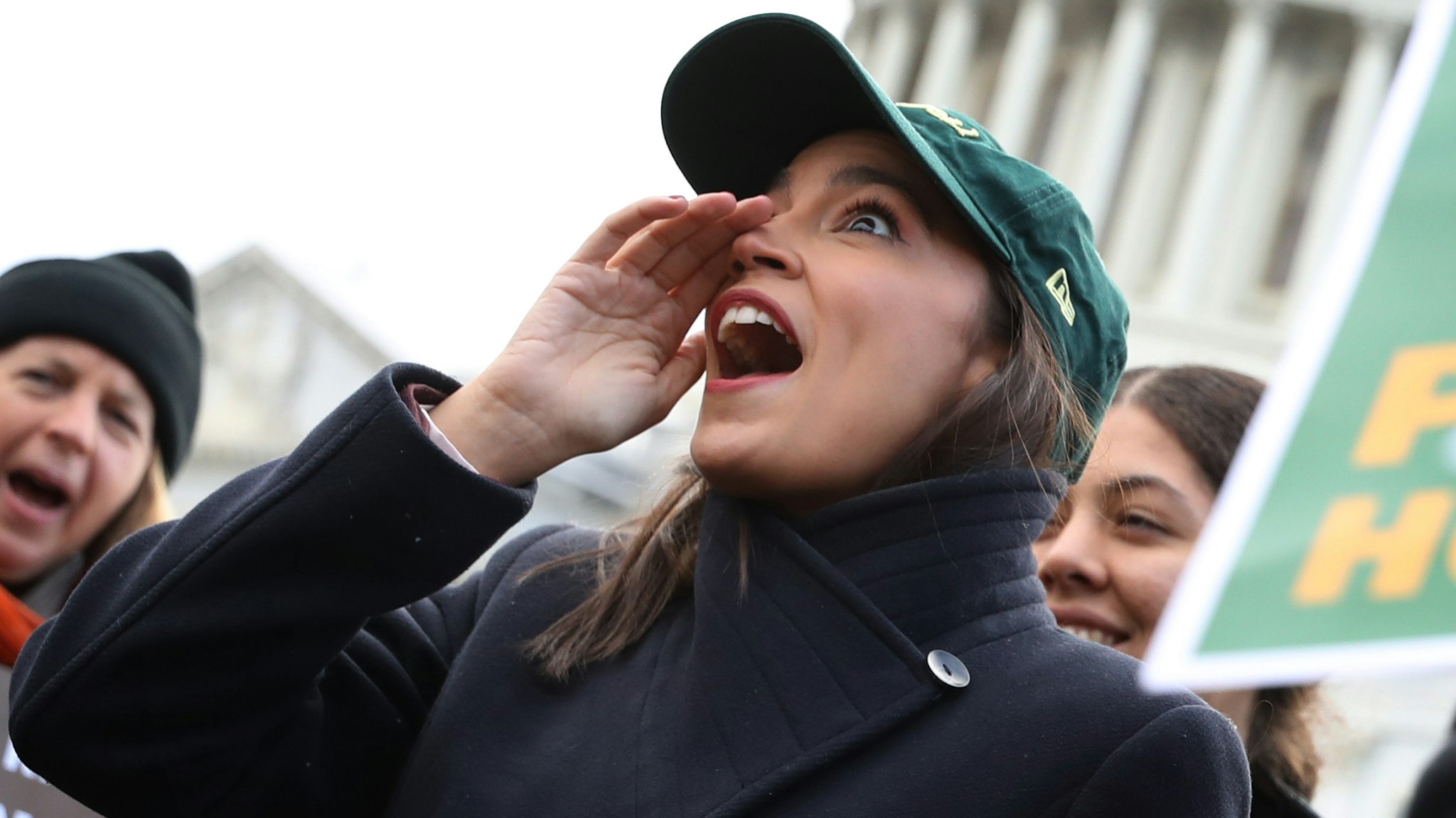WASHINGTON, DC - NOVEMBER 14: Rep. Alexandria Ocasio-Cortez (D-NY) (2nd L) chants with housing and environmental advocates before a news conference to introduce legislation to transform public housing as part of her Green New Deal outside the U.S. Capitol November 14, 2019 in Washington, DC. The liberal legislators invited affordable housing advocates and climate change activists to join them for the announcement.