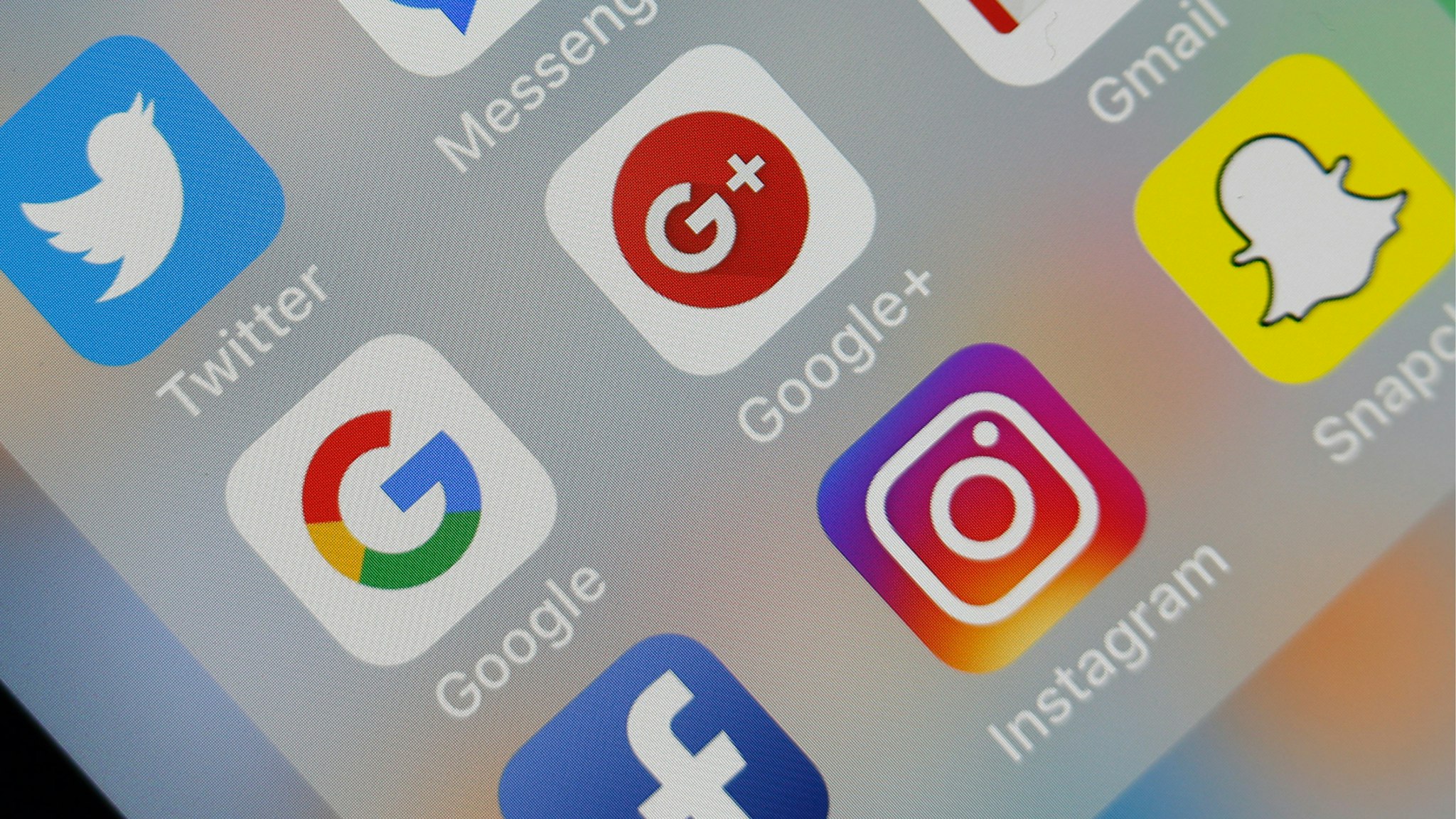 In this photo illustration, the social medias applications logos, Twitter, Google, Google+, Gmail, Facebook, Instagram and Snapchat are displayed on the screen of an Apple iPhone on October 08, 2018 in Paris, France.