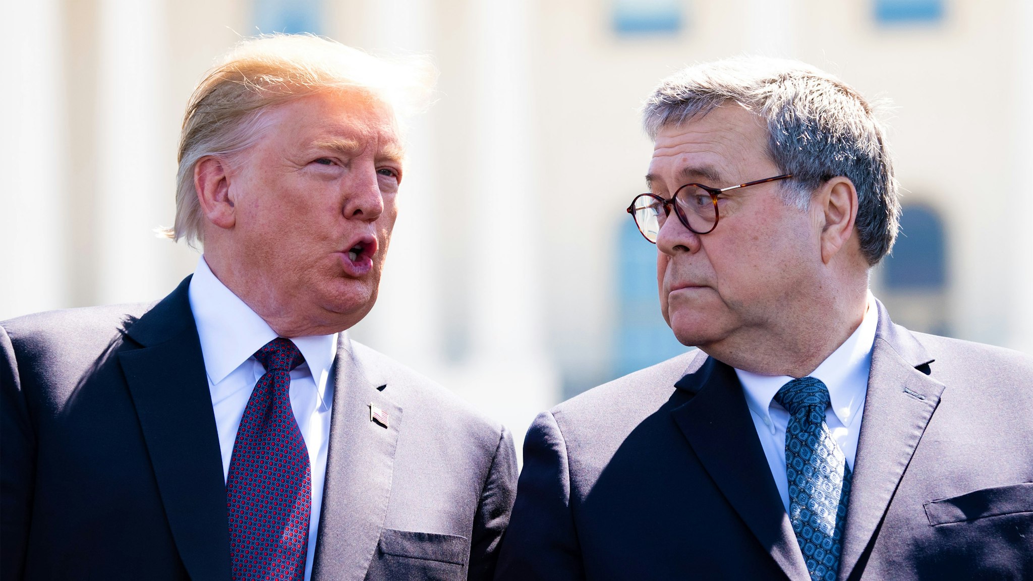 U.S. President Donald Trump, left, speaks to William Barr, U.S. attorney general, during the 38th annual National Peace Officers Memorial Day service at the U.S. Capitol in Washington, D.C., U.S., on Wednesday, May 15, 2019. Trump is poised to delay a decision by up to six months to impose auto tariffs to avoid blowing up negotiations with the EU and Japan and further antagonizing allies as he ramps up his trade war with China, according to people close to the discussions.