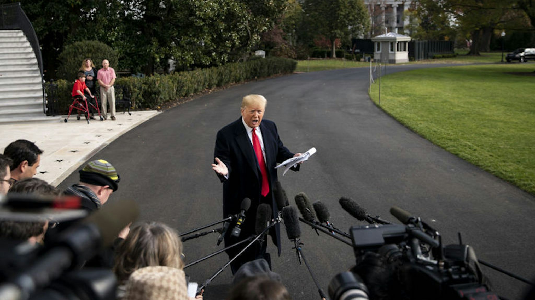 U.S. President Donald Trump speaks to members of the media before boarding Marine One on the South Lawn of the White House in Washington, D.C., U.S., on Wednesday, Nov. 20, 2019. The House Intelligence Committee is hearing from Gordon Sondland, the U.S. ambassador to the European Union, on the fourth day of public testimony in the impeachment inquiry into President Trump. Photographer: Al
