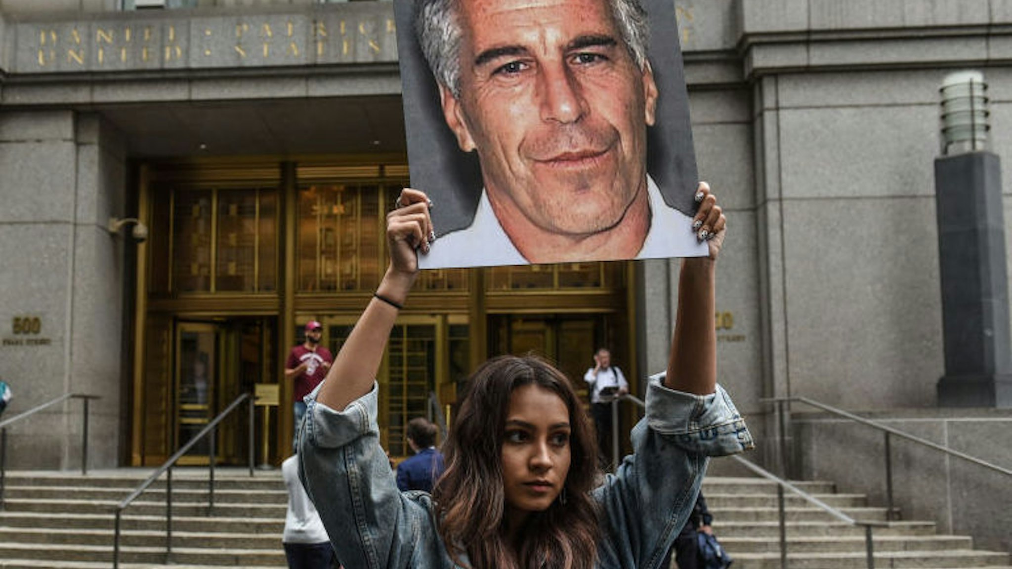 NEW YORK, NY - JULY 08: A protest group called "Hot Mess" hold up signs of Jeffrey Epstein in front of the federal courthouse on July 8, 2019 in New York City. According to reports, Epstein will be charged with one count of sex trafficking of minors and one count of conspiracy to engage in sex trafficking of minors.