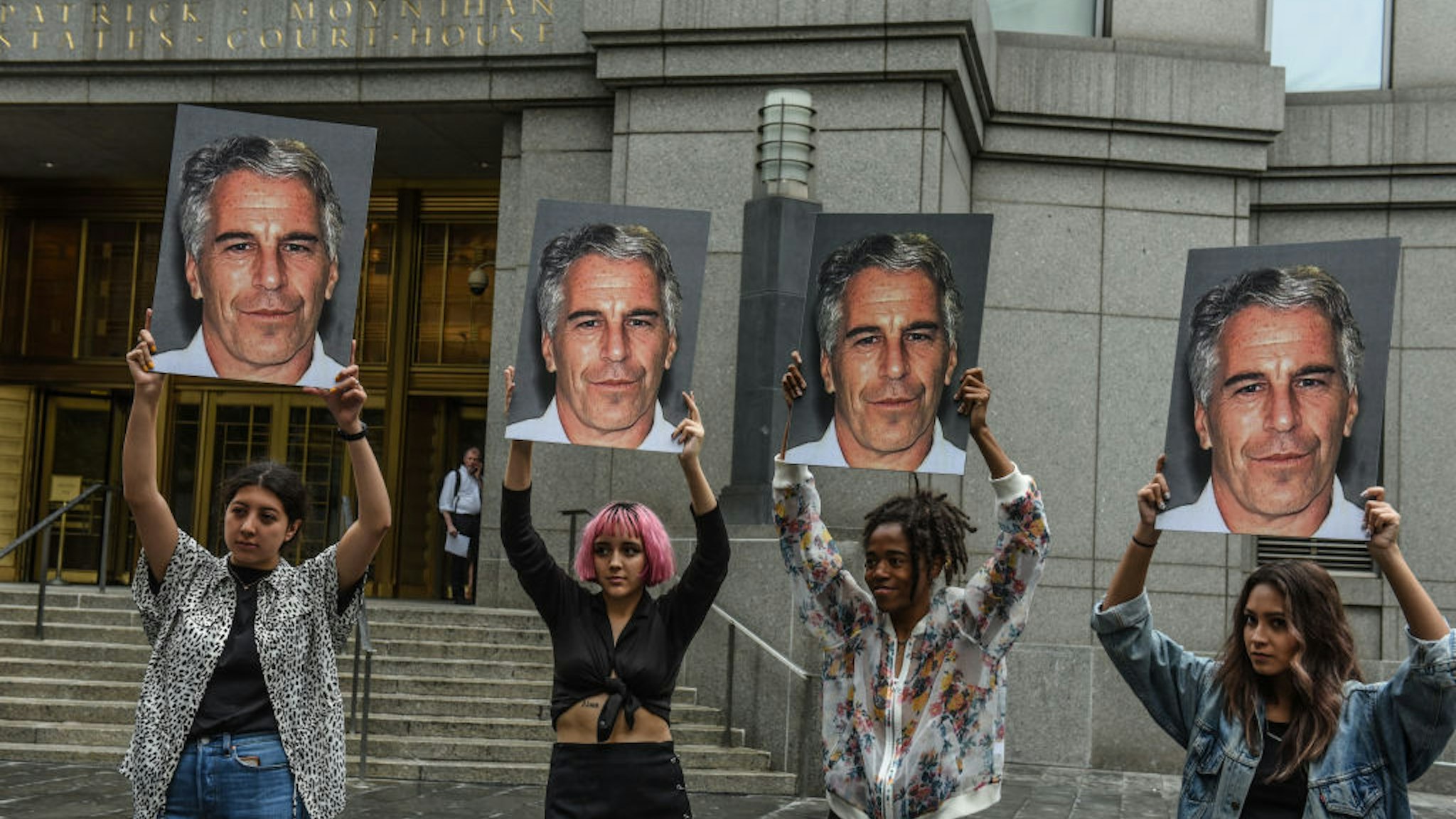 A protest group called "Hot Mess" hold up signs of Jeffrey Epstein in front of the Federal courthouse on July 8, 2019 in New York City. According to reports, Epstein will be charged with one count of sex trafficking of minors and one count of conspiracy to engage in sex trafficking of minors. (Photo by Stephanie Keith/Getty Images)