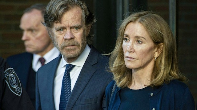 TOPSHOT - Actress Felicity Huffman, escorted by her husband William H. Macy, exits the John Joseph Moakley United States Courthouse in Boston, where she was sentenced by Judge Talwani for her role in the College Admissions scandal on September 13, 2019. - Actress Felicity Huffman gets 14 days jail in US college admissions scandal