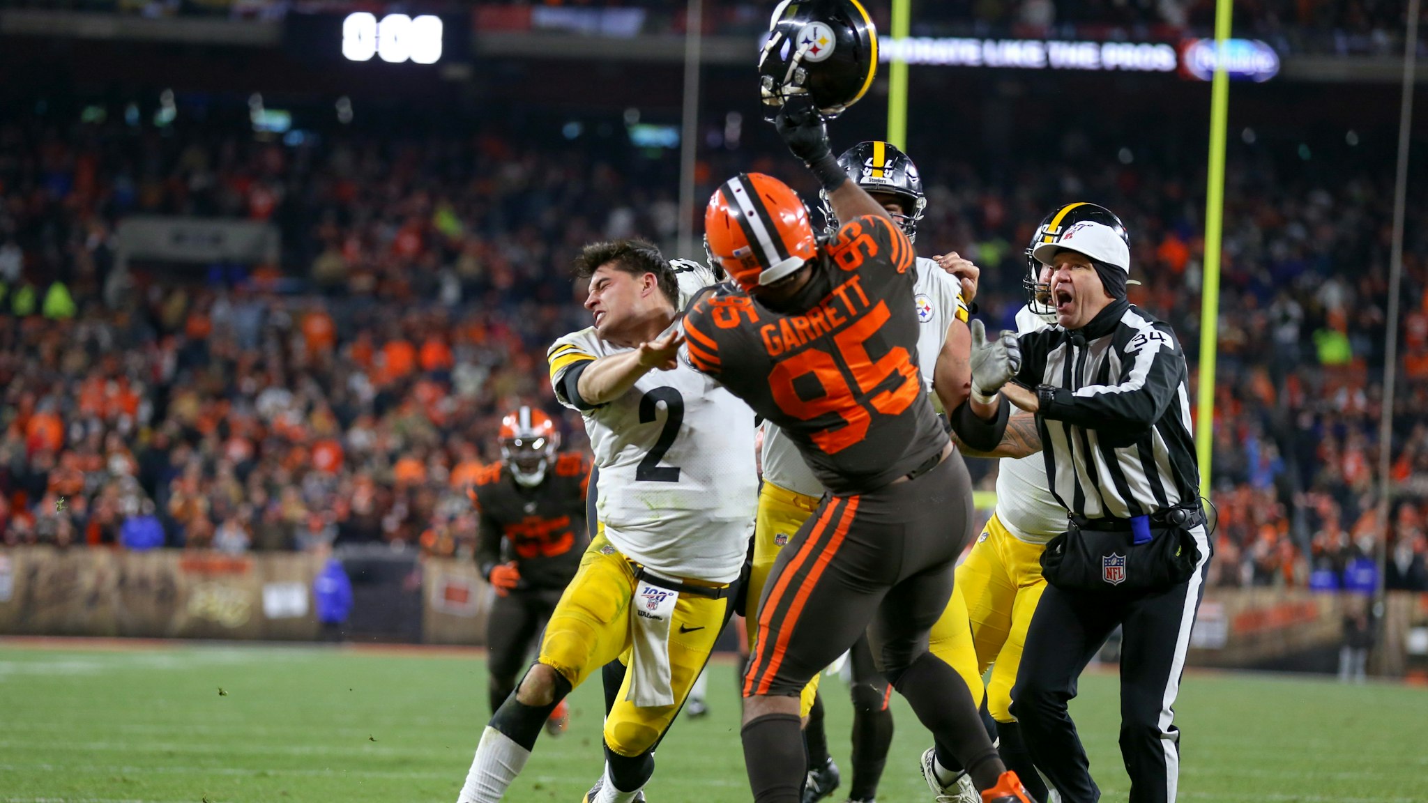 Cleveland Browns defensive end Myles Garrett (95) swings at Pittsburgh Steelers quarterback Mason Rudolph (2) with Rudolphs own helmet with 0:08 seconds left in the fourth quarter of the National Football League game between the Pittsburgh Steelers and Cleveland Browns on November 14, 2019, at FirstEnergy Stadium in Cleveland, OH.