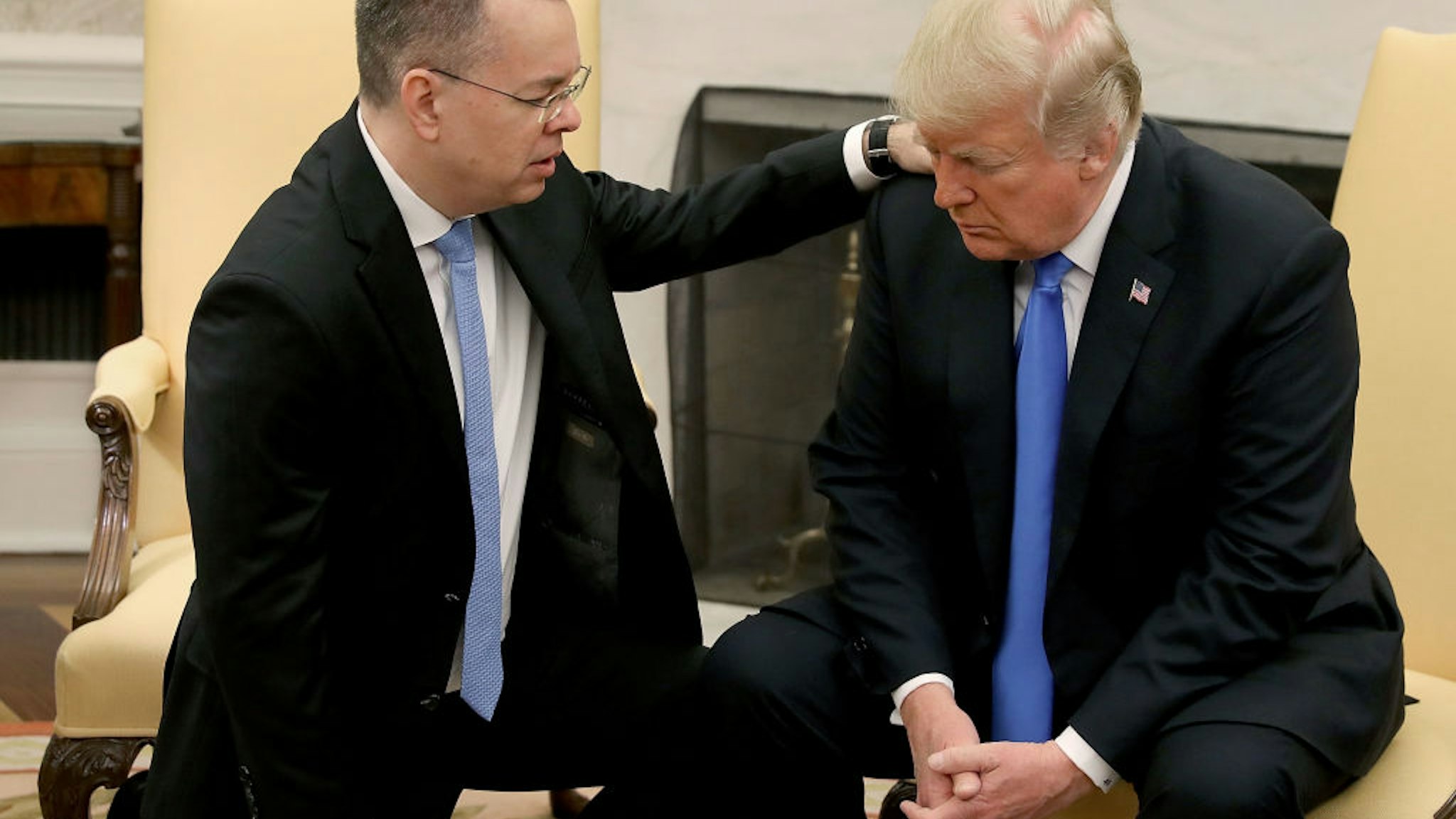 U.S. President Donald Trump and American evangelical Christian preacher Andrew Brunson (L) participate in a prayer in the Oval Office a day after Brunson was released from a Turkish jail, at the White House on October 13, 2018 in Washington, DC.