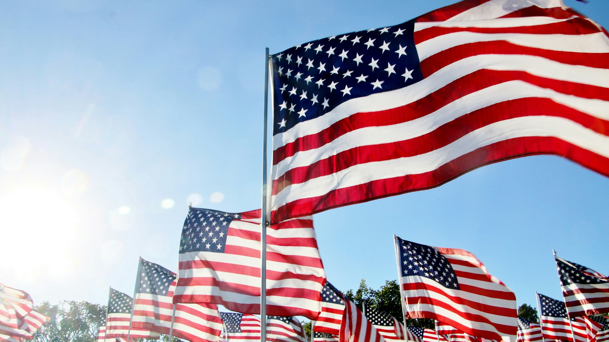 United States flags blow in the wind in Malibu, CA - stock photo