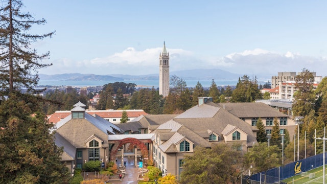 BERKELEY, CA - DECEMBER 1: A general view of the University of California Berkeley campus including Sather Tower, also known as The Campanile, as seen from Memorial Stadium before the 121st Big Game played between the California Golden Bears and the Stanford Cardinal football teams on December 1, 2018 at the University of California in Berkeley, California. The Haas School of Business is visible in foreground (with gabled roofs), San Francisco Bay in the background.