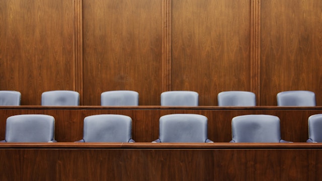 Empty chairs in jury box - stock photo