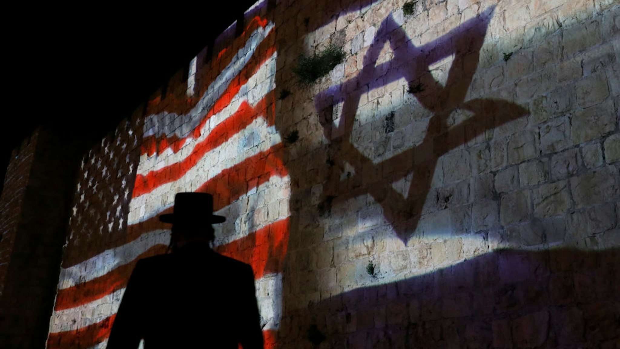 The Israeli and United States flags are projected on the walls of the ramparts of Jerusalem's Old City, to mark one year since the transfer of the US Embassy from Tel Aviv to Jerusalem on May 15, 2019.
