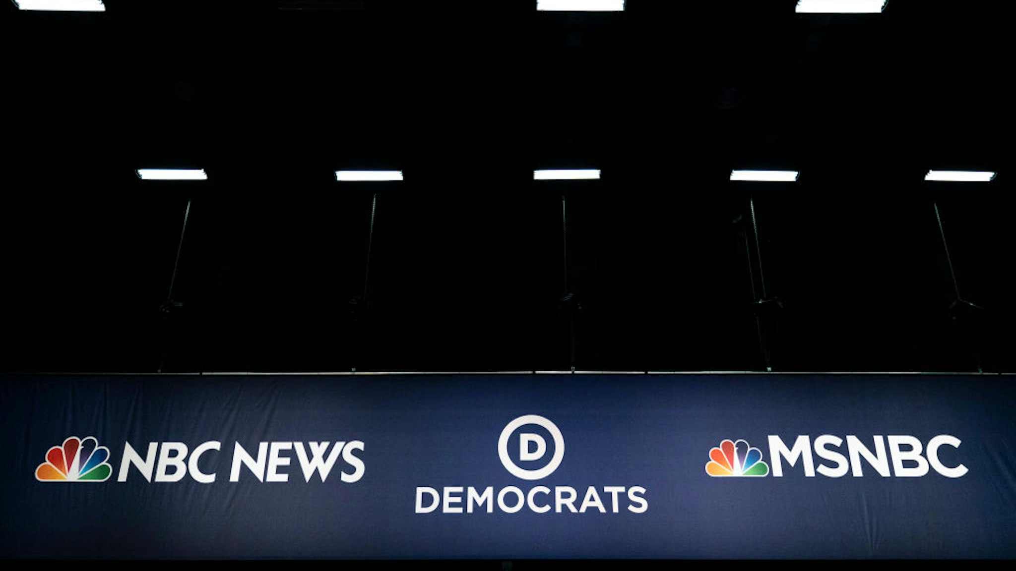 Advertising signage for NBC News and the Democratic Party is seen inside the media filing center at Adrienne Arsht Center for the Performing Arts where the first Democratic presidential primary debates for the 2020 elections will take place, June 25, 2019 in Miami, Florida.