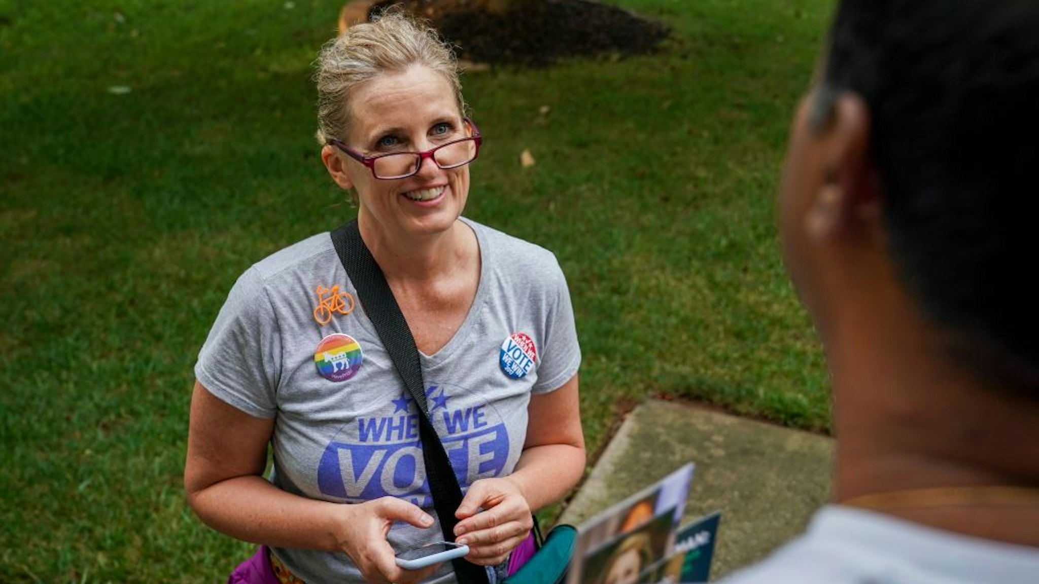 Juli Briskman, the Democratic nominee for Supervisor of Loudoun County's Algonkian District, chats with Hari Moosani as she campaigns door-to-door in her neighborhood on Wednesday, July 17, 2019, in Sterling, VA.