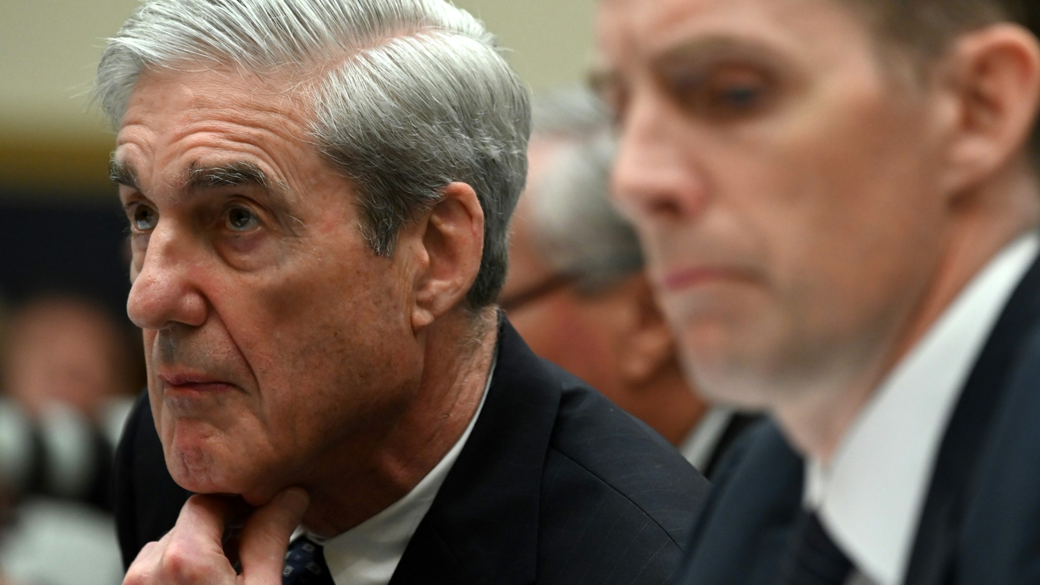ormer Deputy Special Counsel Aaron Zebley (R) takes notes during testimony by former Special Prosecutor Robert Mueller (L) during a hearing before Congress on July 24, 2019, in Washington, DC. - Mueller told US lawmakers Wednesday that his report on Russia election interference does not exonerate Donald Trump, as the president has repeatedly asserted. (Photo by ANDREW CABALLERO-REYNOLDS / AFP) (Photo credit should read ANDREW CABALLERO-REYNOLDS/AFP via Getty Images)