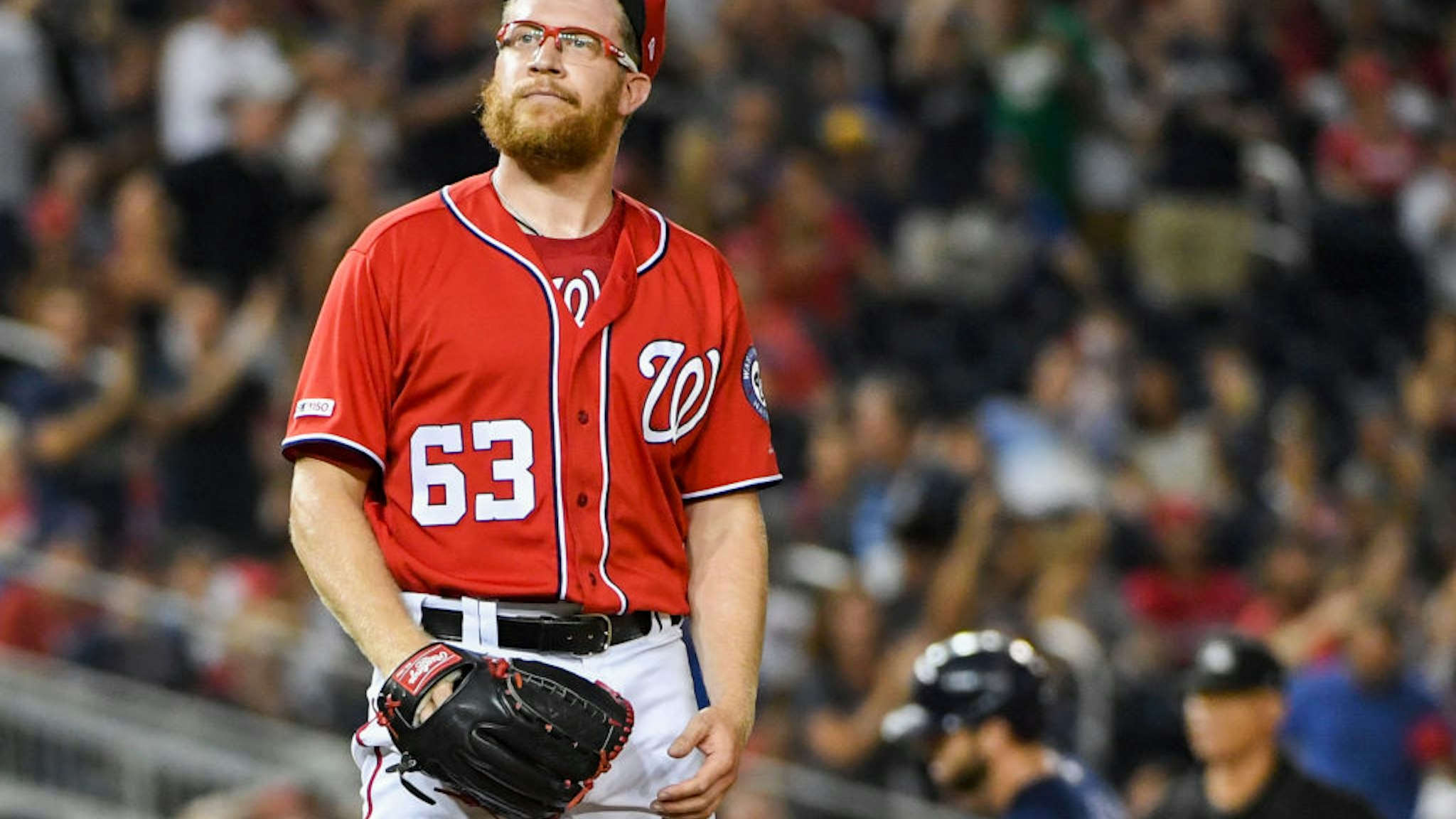 Washington Nationals relief pitcher Sean Doolittle (63) reacts after giving up a two run home run to Milwaukee Brewers third baseman Mike Moustakas (11) in the ninth inning at Nationals Park.