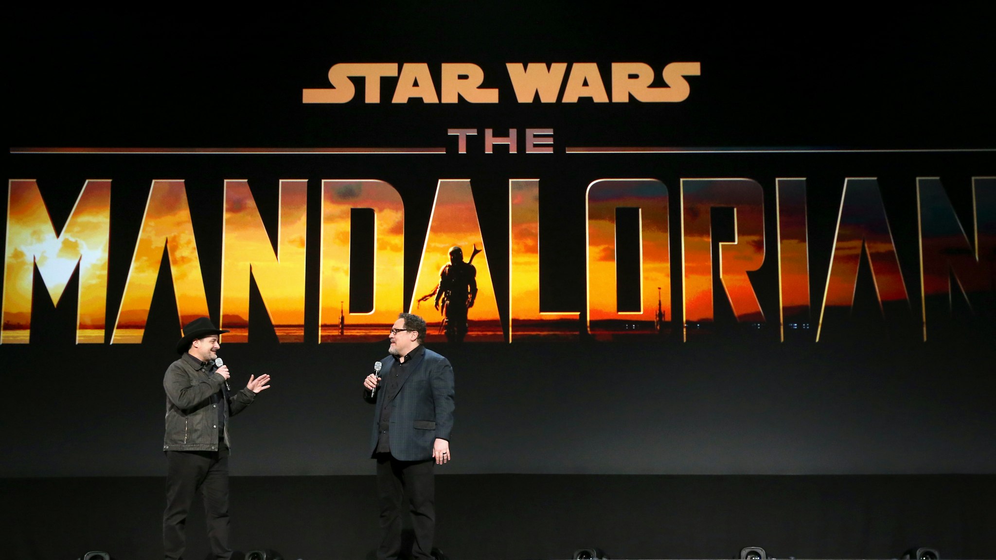 ANAHEIM, CALIFORNIA - AUGUST 23: Executive producer/writers Dave Filoni and Jon Favreau of 'The Mandalorian' took part today in the Disney+ Showcase at Disney’s D23 EXPO 2019 in Anaheim, Calif. 'The Mandalorian' will stream exclusively on Disney+, which launches November 12. (Photo by Jesse Grant/Getty Images for Disney)