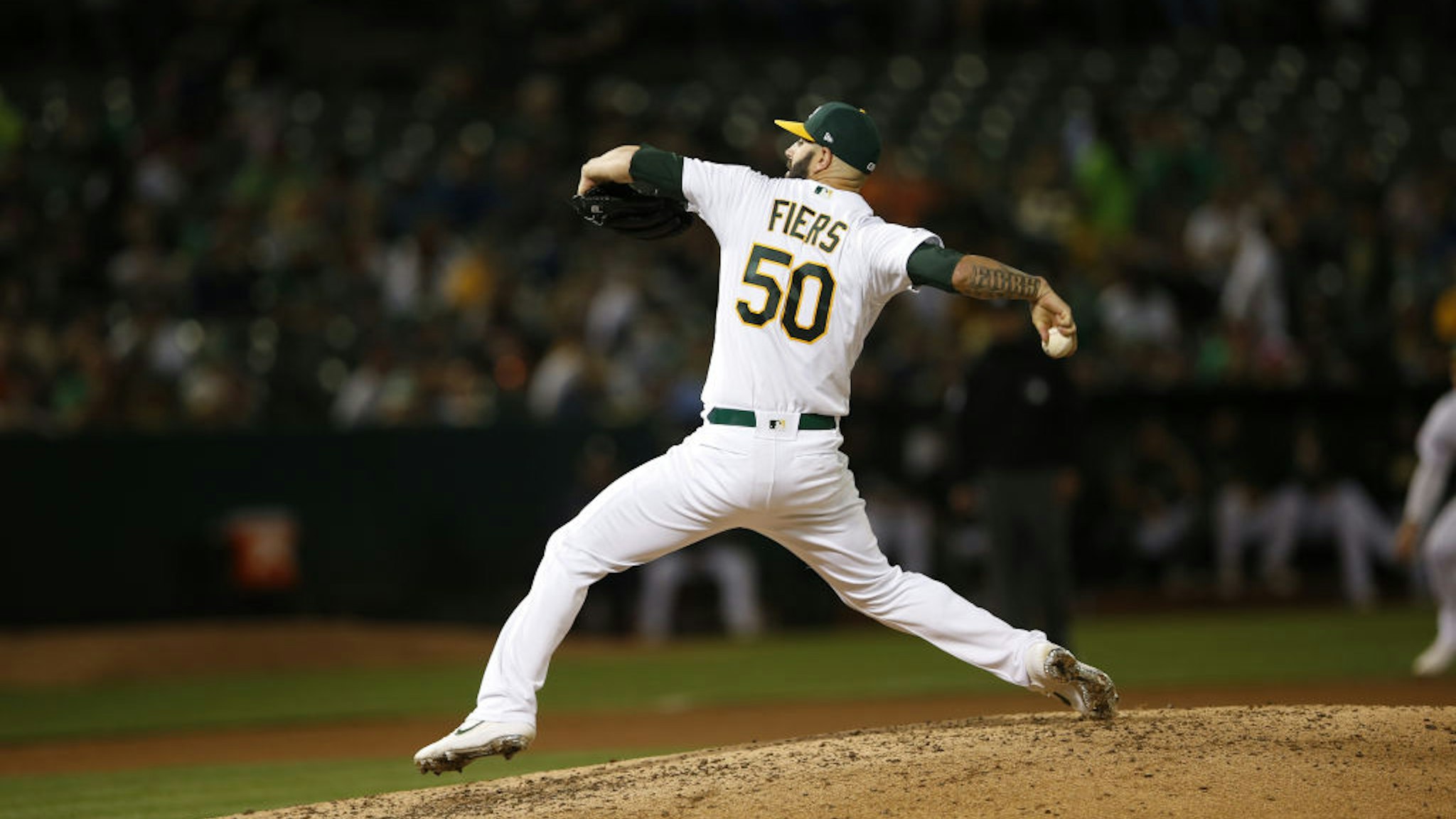 Mike Fiers #50 of the Oakland Athletics pitches during the game against the New York Yankees at the Oakland-Alameda County Coliseum on August 21, 2019 in Oakland, California.