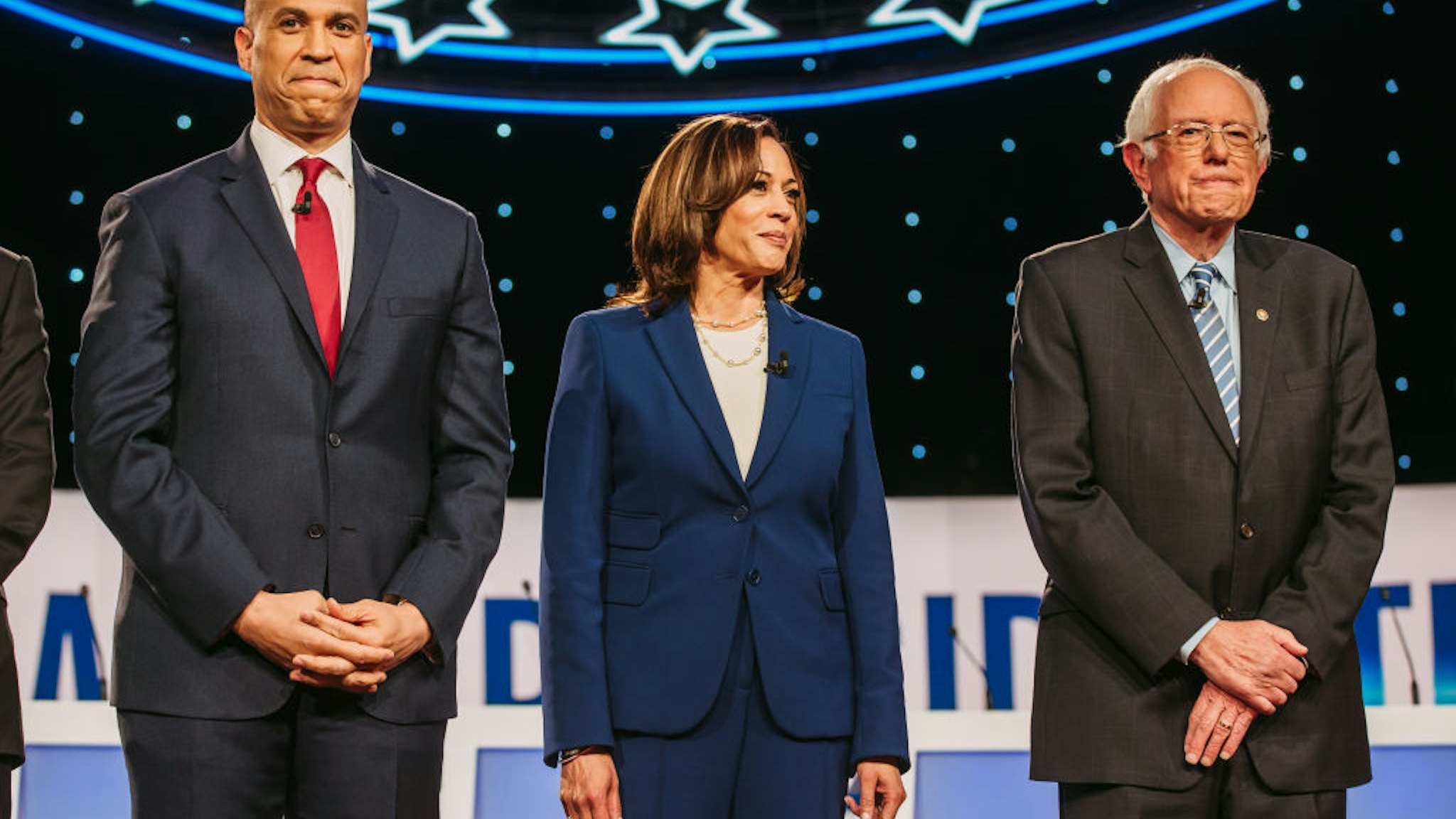 2020 Democratic presidential candidates Senator Cory Booker, a Democrat from New Jersey, from left, Senator Kamala Harris, a Democrat from California, and Senator Bernie Sanders, an independent from Vermont, arrive on stage for the Democratic presidential candidate debate in Westerville, Ohio, U.S., on Tuesday, Oct. 15, 2019.