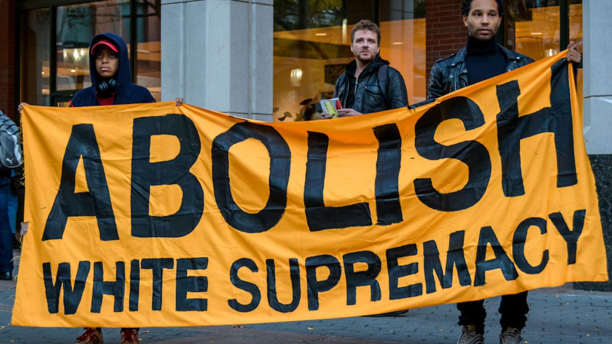 Protesters holding an ABOLISH WHITE SUPREMACY banner at the rally in Metrotech Plaza.