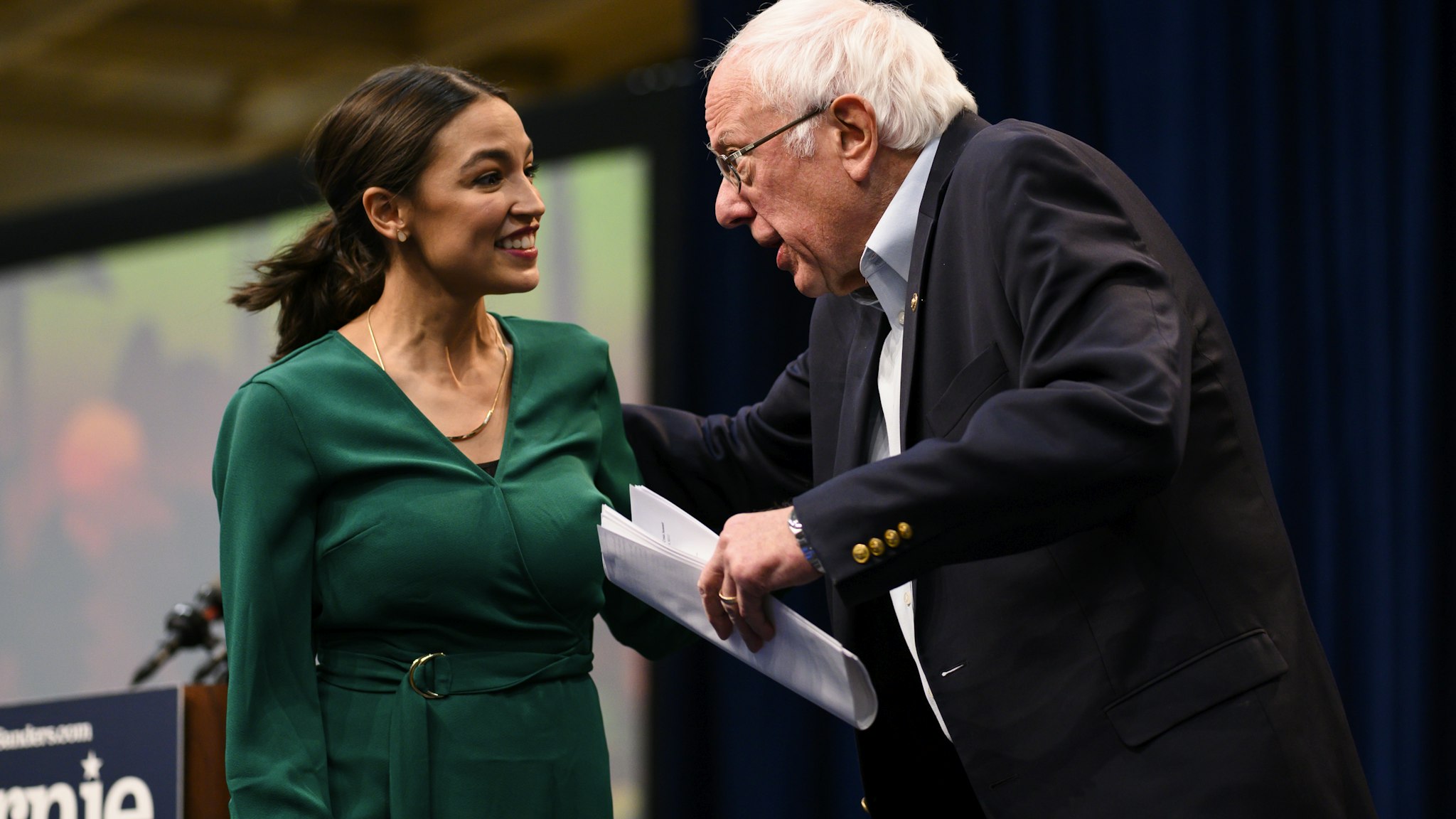 DES MOINES, IA - NOVEMBER 09: U.S. Rep. Alexandria Ocasio-Cortez (D-NY) is joined on stage by Democratic Presidential candidate Bernie Sanders (I-VT) during the Climate Crisis Summit at Drake University on November 9, 2019 in Des Moines, Iowa. Sanders, Ocasio-Cortez, and author Naomi Klein spoke about the current state of climate change in relation to U.S. policy. (Photo by Stephen Maturen/Getty Images)