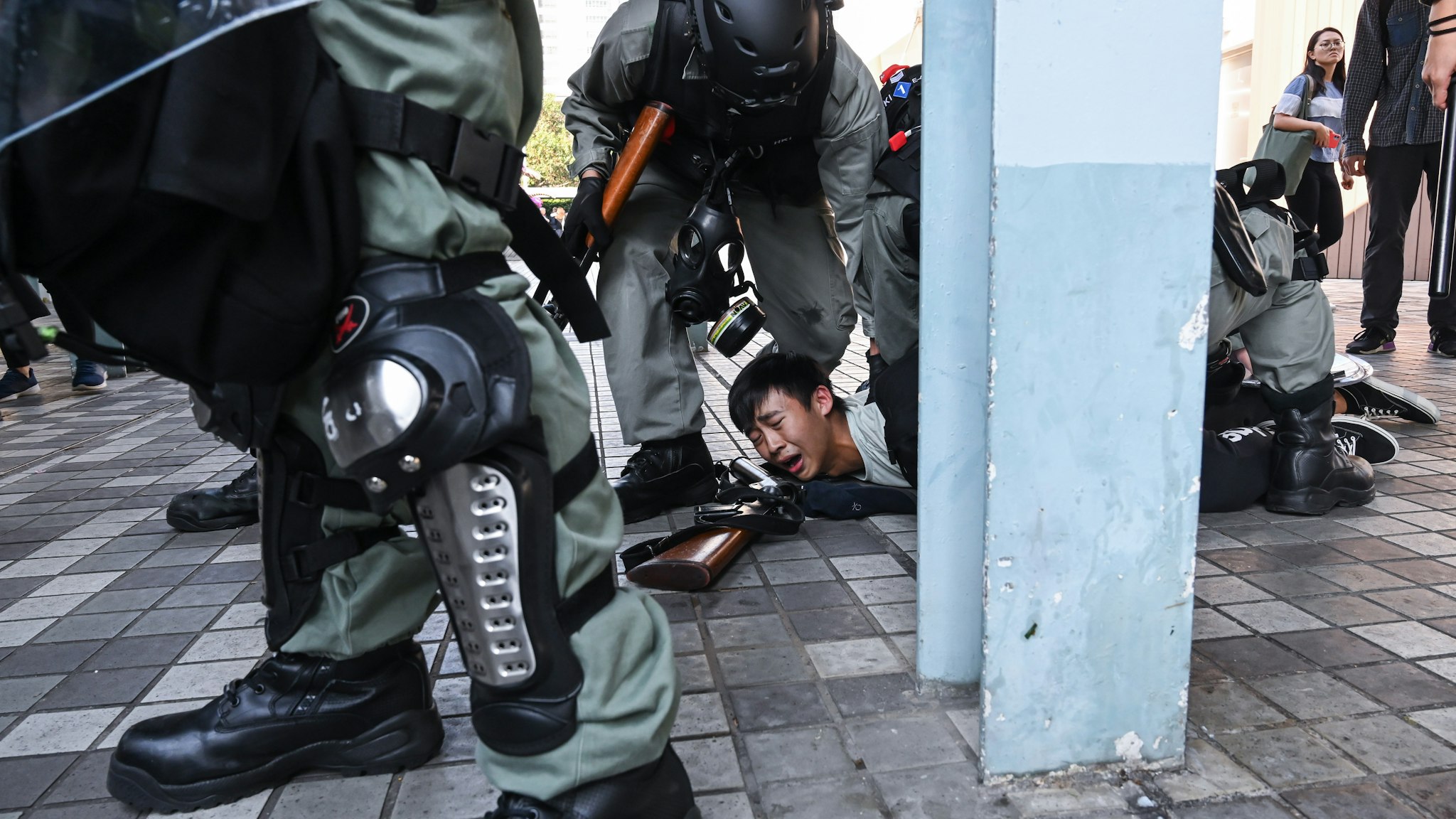 HONG KONG, CHINA - NOVEMBER 11: A protestor arrested by riot police in Wong Tai Sin district on November 11, 2019 in Hong Kong, China. Anti-government protesters organized a general strike on Monday as demonstrations in Hong Kong stretched into its sixth month with demands for an independent inquiry into police brutality, the retraction of the word "riot" to describe the rallies, and genuine universal suffrage. (Photo by Billy H.C. Kwok/Getty Images)