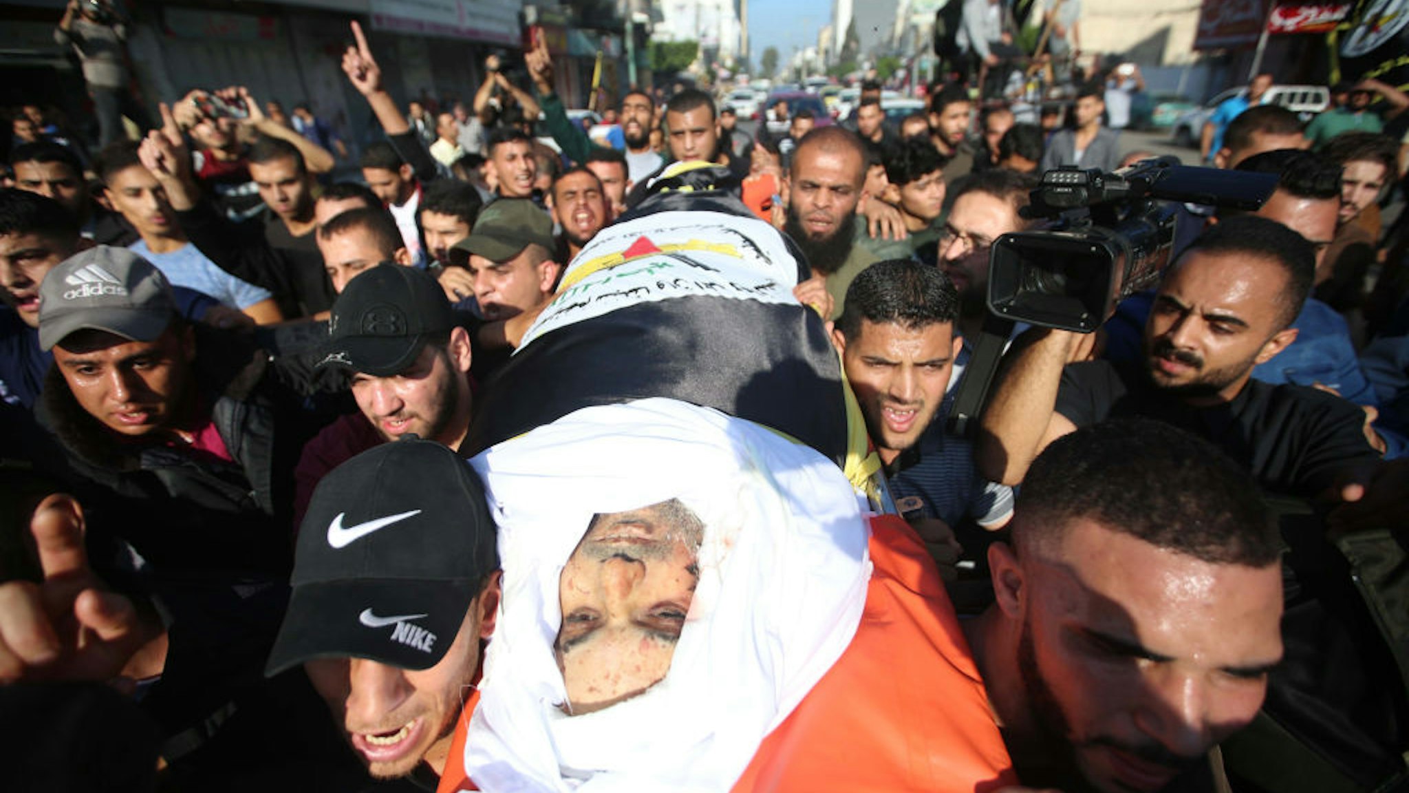 Mourners chant slogans as they carry the body of Palestinian Islamic Jihad senior leader Baha Abu Al-Ata during his funeral in Gaza City on November 12, 2019.