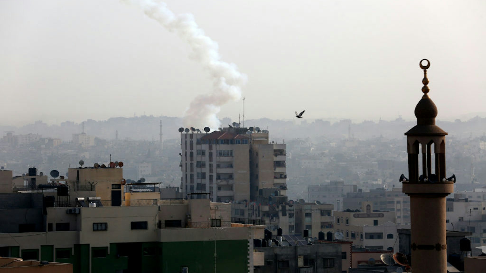 A Palestinian rocket is pictured in the air after being fired from Gaza city on November 13, 2019. - Israel's military killed a commander from Palestinian militant group Islamic Jihad in a strike on his home in the Gaza Strip, triggering exchanges of fire in a violent escalation that left another nine Gazans dead.