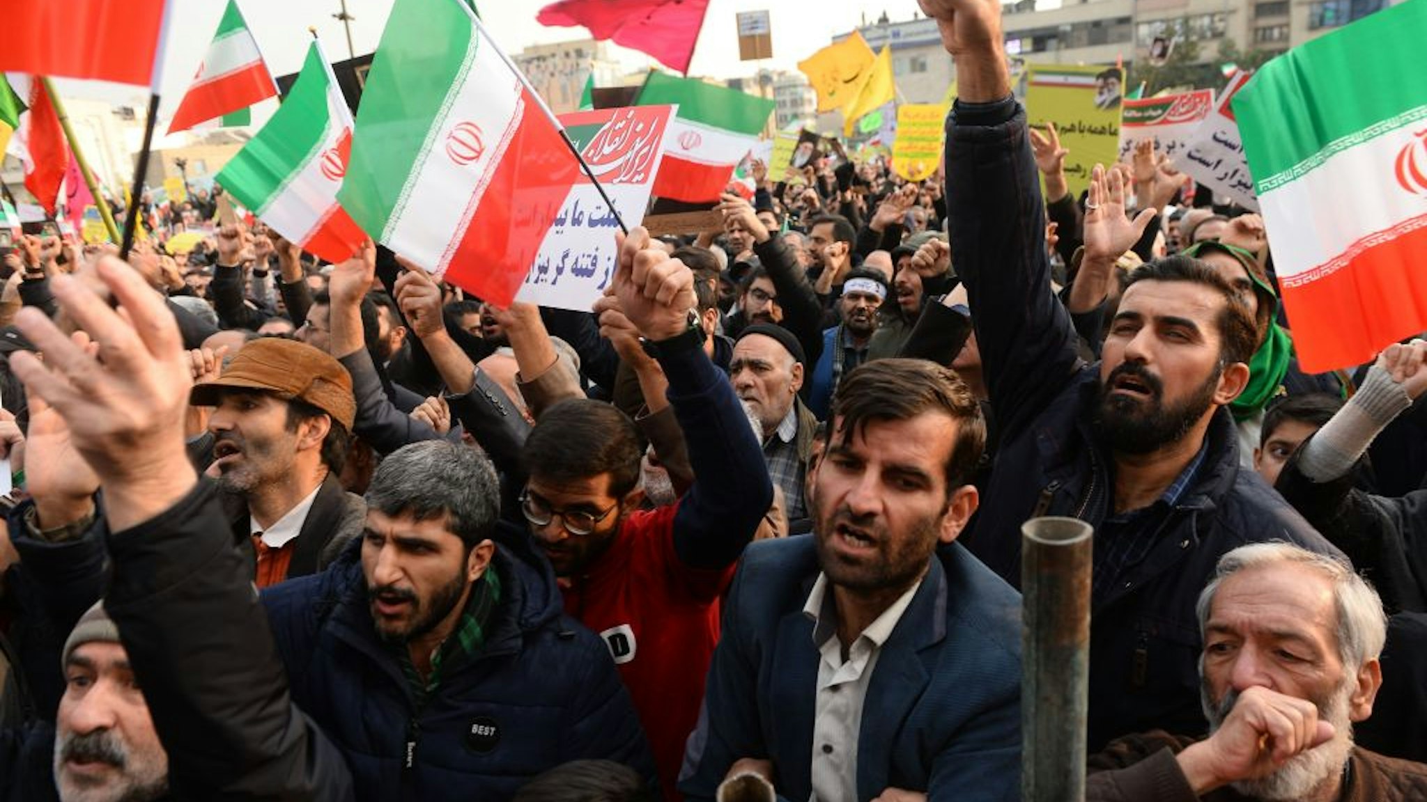 Demonstrators gather during a pro-government demonstration to react to protests due to fuel price increase of Iran, on November 25, 2019 in Tehran, Iran.