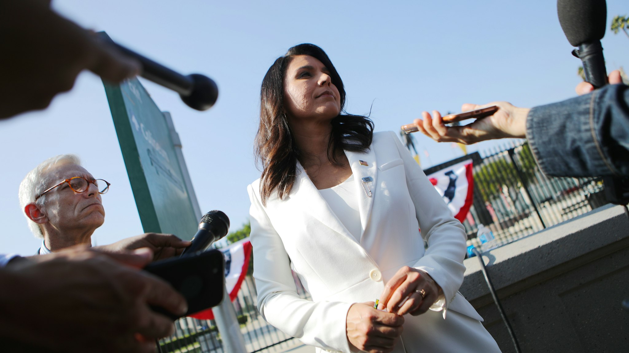 LOS ANGELES, CALIFORNIA - NOVEMBER 11: Democratic presidential candidate U.S. Rep. Tulsi Gabbard (D-HI) meets with reporters at the inaugural Veterans Day L.A. event held outside of the Los Angeles Memorial Coliseum on November 11, 2019 in Los Angeles, California. The stadium's historic torch was lit at the ceremony to mark the anniversary of the armistice which ended World War I in 1918. Gabbard is the first female combat veteran to run for the U.S. presidency. (Photo by Mario Tama/Getty Images)