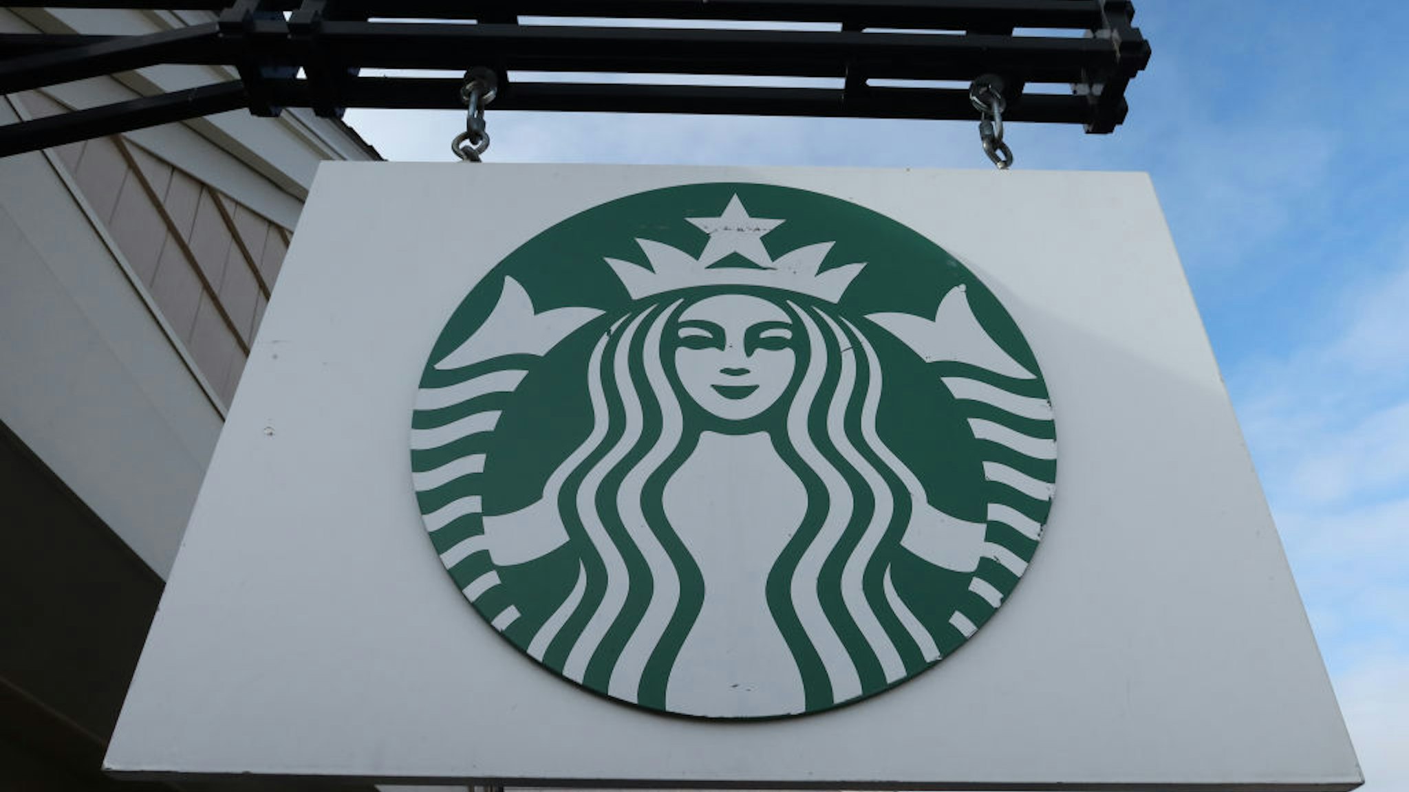 A Starbucks sign hangs in front of their store at the Woodbury Common Premium Outlets shopping mall on November 17, 2019 in Central Valley, New York.