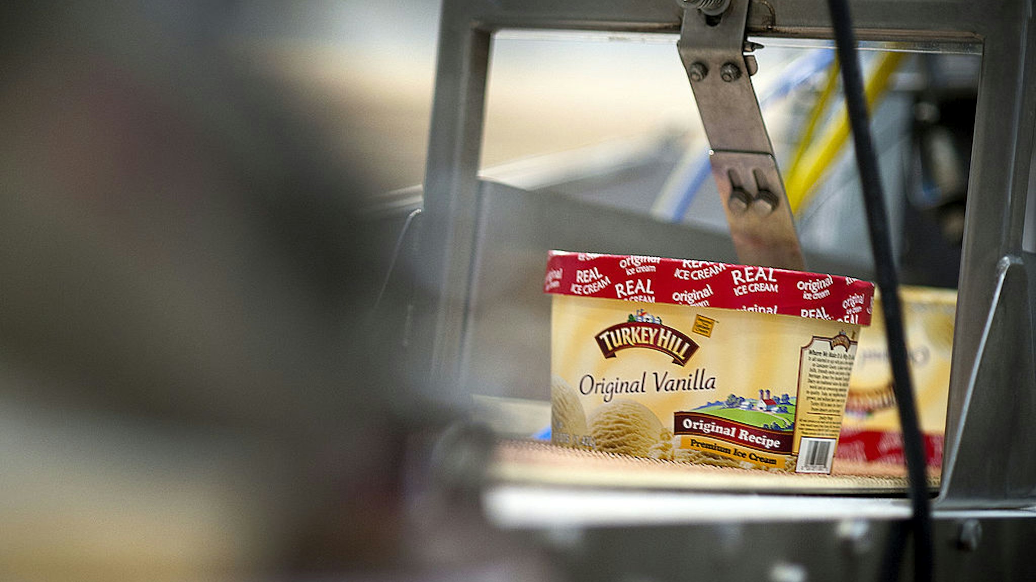 Packages of vanilla ice cream move along a conveyer belt at Turkey Hill LP's production facility in Contestoga, Pennsylvania, U.S., on Monday, Nov. 21, 2011.