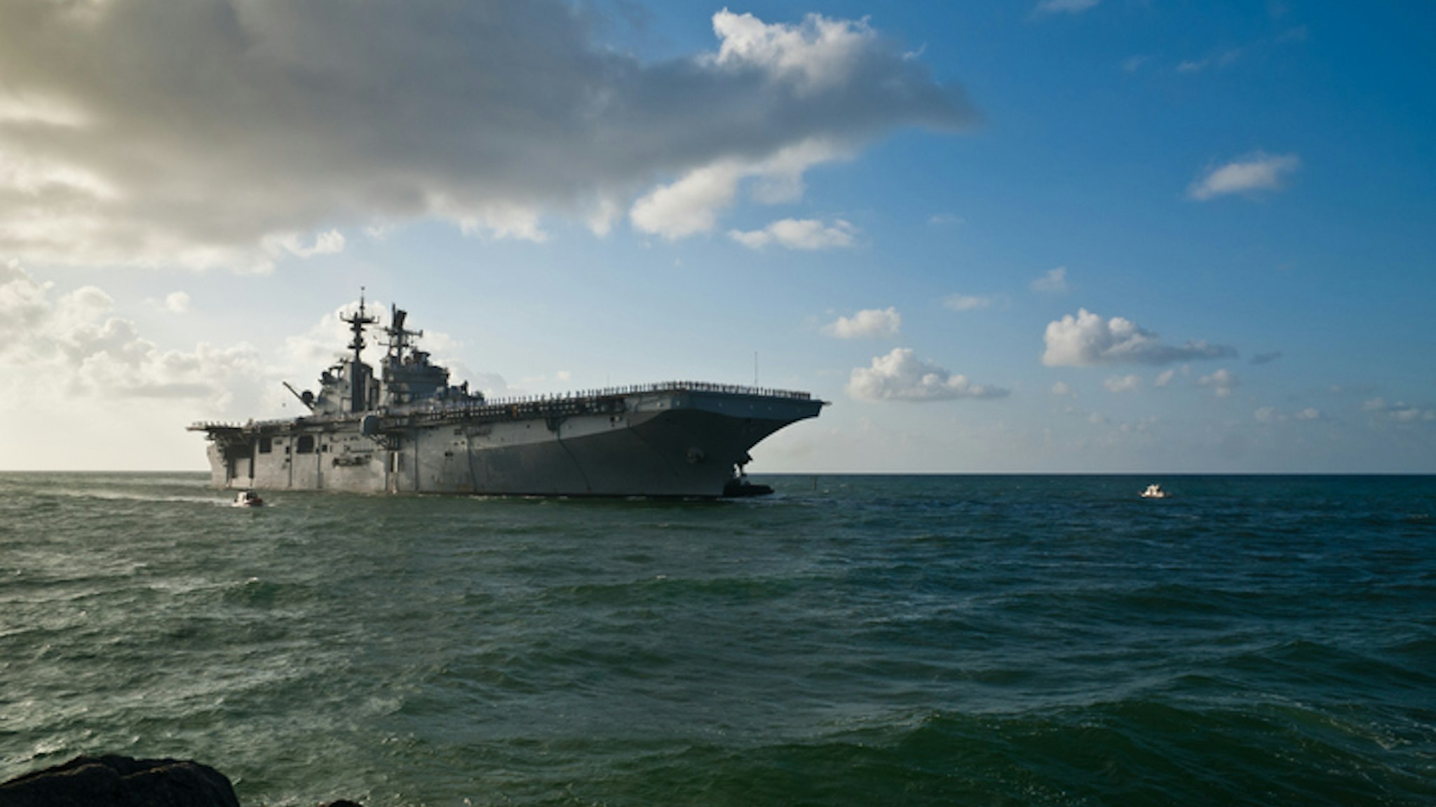 Morning sun illuminates the USS Iwo Jima (LHD-7) as she sails into Port Everglades in Fort Lauderdale, Fl..