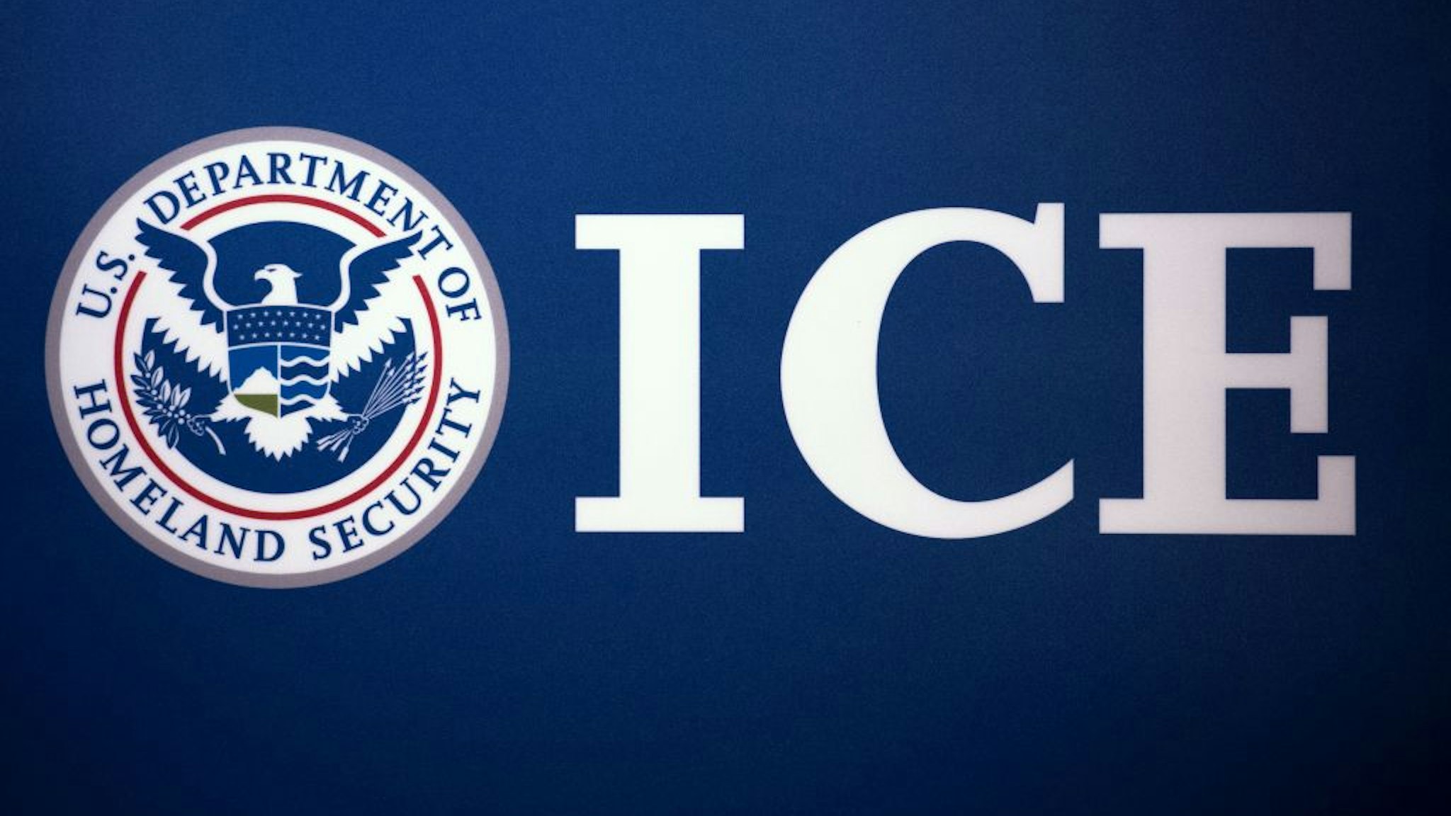 The Immigration and Customs Enforcement (ICE) seal is seen before a press conference discussing ongoing enforcement efforts to combat human smuggling along the Southwest border of the United States, July 22, 2014 at ICE headquarters in Washington, DC.