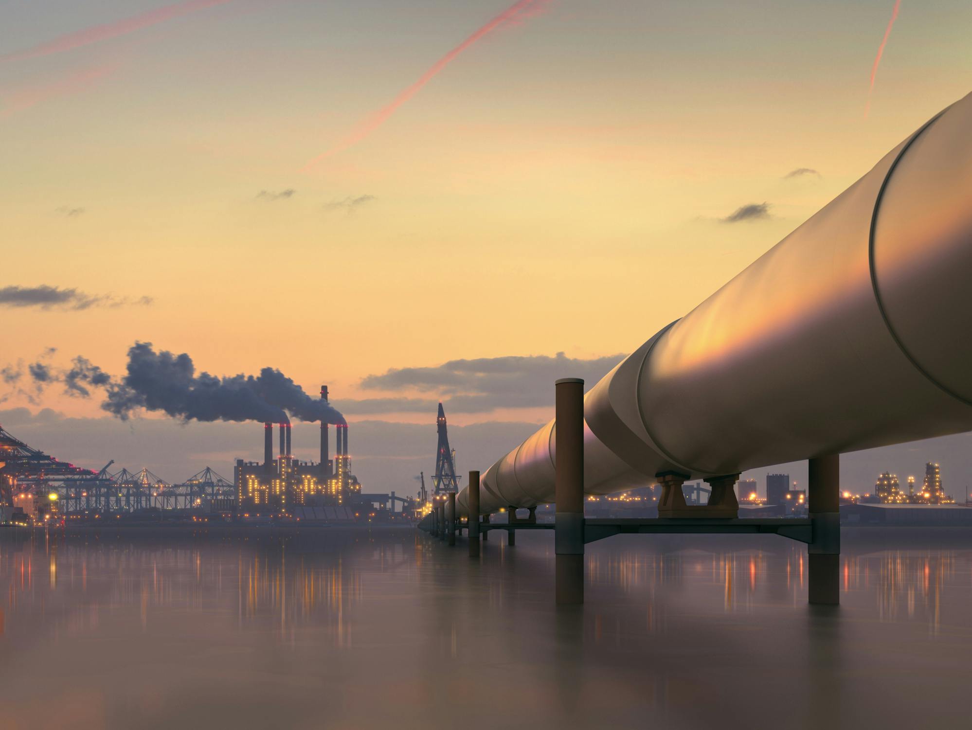 Oil pipeline in industrial district with factories at dusk - stock photo Pipeline in industrial district