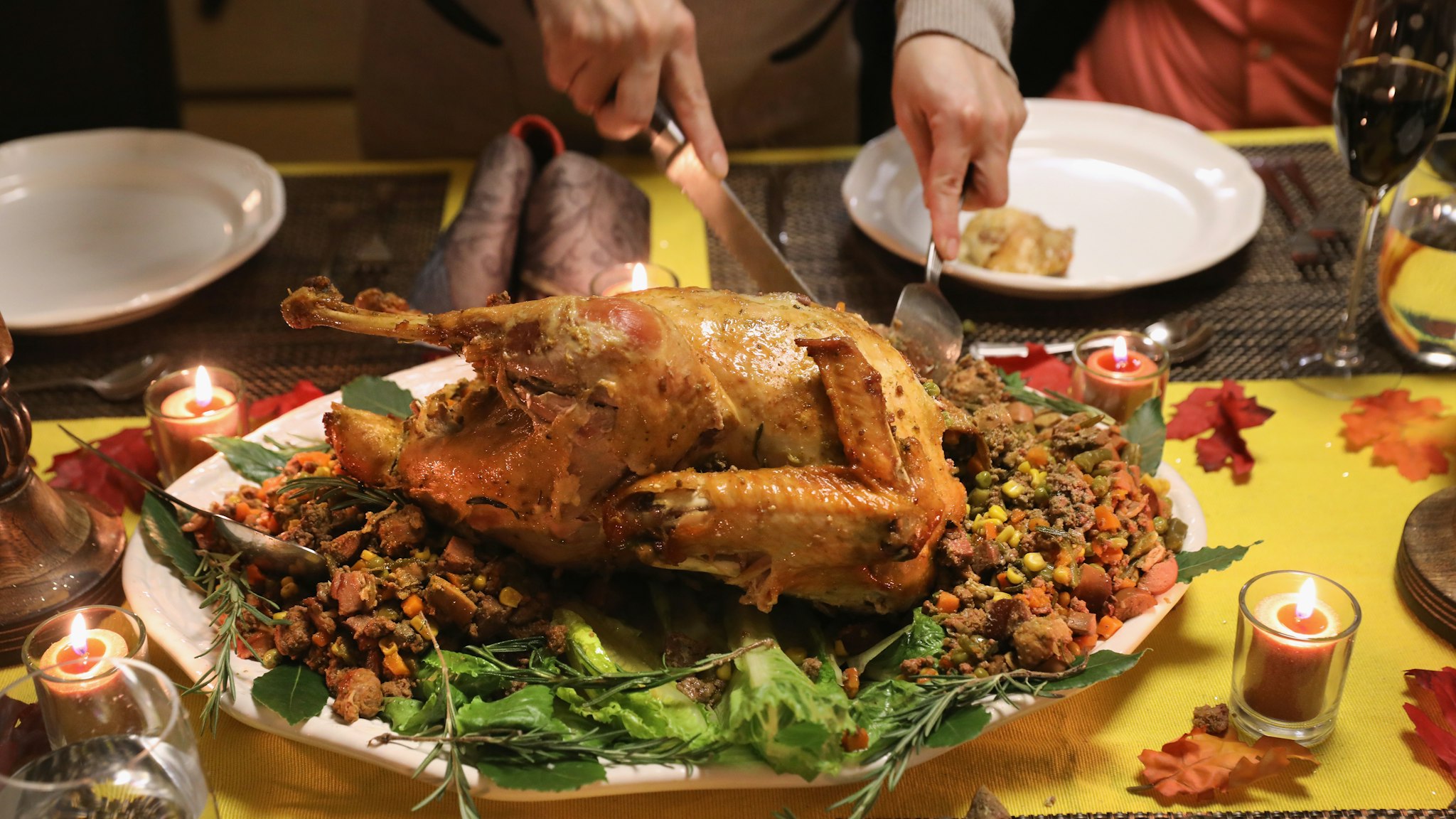 A Guatemalan immigrant carves the Thanksgiving turkey on November 24, 2016 in Stamford, Connecticut. Family and friends, some of them U.S. citizens, others on work visas and some undocumented immigrants came together in an apartment to celebrate the American holiday with turkey and Latin American dishes. They expressed concern with the results of the U.S. Presidential election of president-elect Donald Trump, some saying their U.S.-born children fear the possibilty their parents will be deported after Trump's inauguration. (Photo by John Moore/Getty Images)