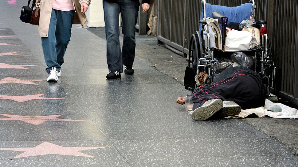 In this 16 October 2006 file photo, a homeless man sleeps on the walk of stars on Hollywood Boulevard in Hollywood, California.