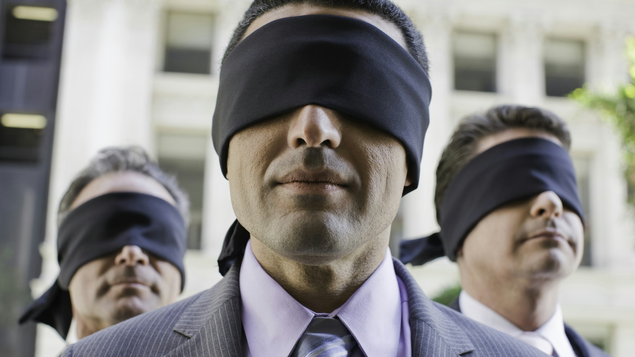 Three blindfolded businessmen - stock photo USA, California, San Francisco