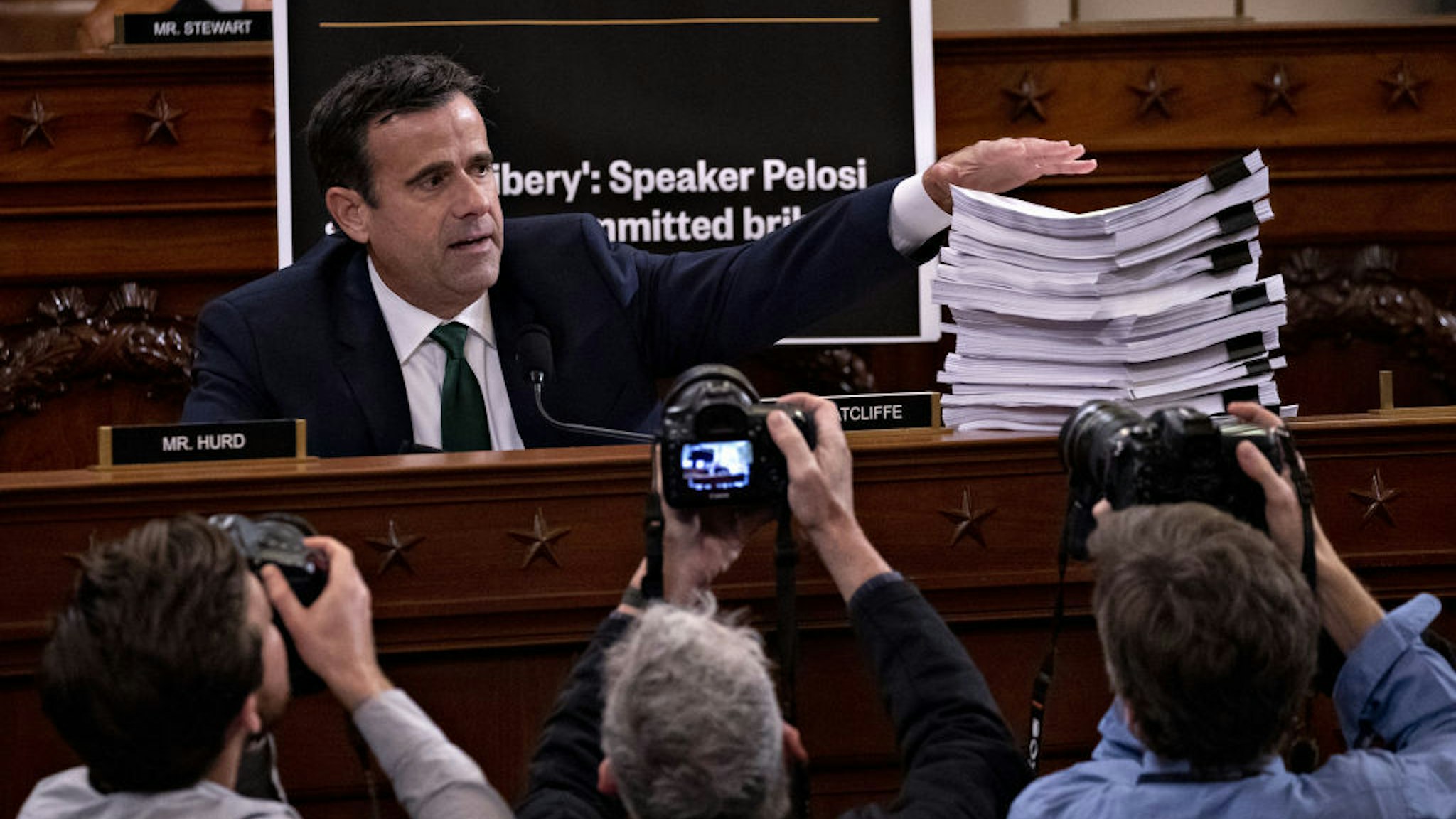 Representative John Ratcliffe, a Republican from Texas, displays a stack of sworn testimony while questioning witnesses during a House Intelligence Committee impeachment inquiry hearing in Washington, D.C., U.S., on Tuesday, Nov. 19, 2019. The committee plans to hear from eight witnesses in open hearings this week in the impeachment inquiry into President Donald Trump. Photographer: Andrew Harrer/Bloomberg