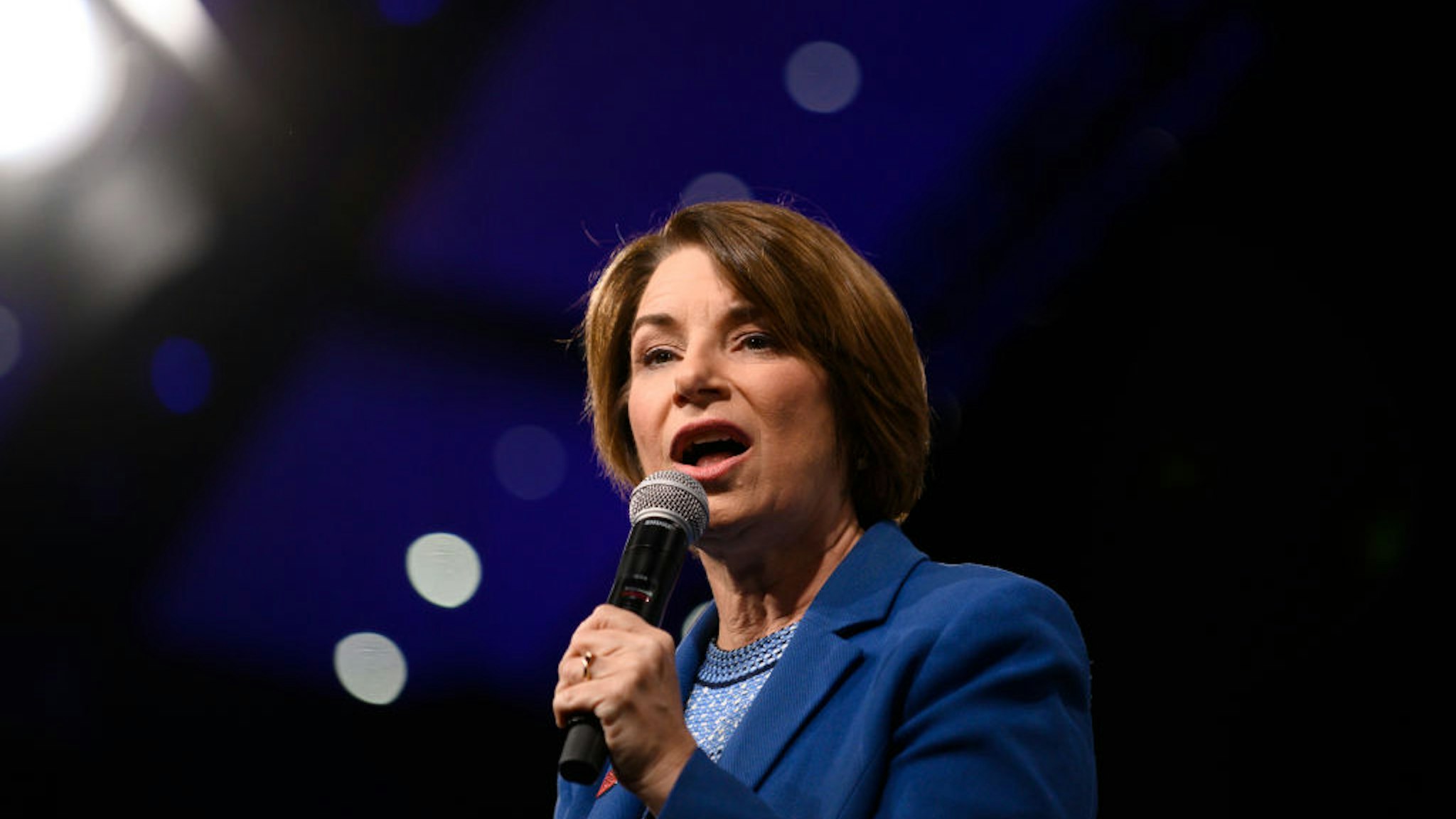 Amy Klobuchar speaks on stage during a forum on gun safety at the Iowa Events Center