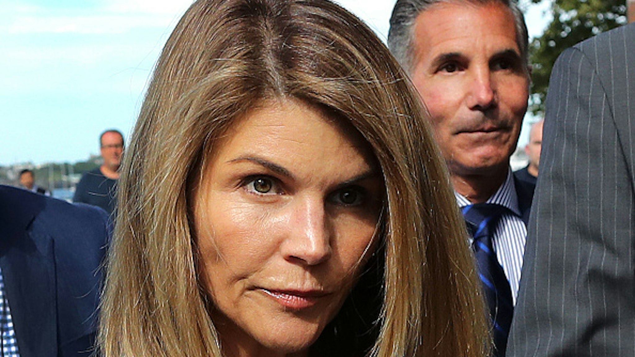 BOSTON, MA - AUGUST 27: Lori Loughlin and her husband Mossimo Giannulli, right, leave the John Joseph Moakley United States Courthouse in Boston on Aug. 27, 2019. A judge says actress Lori Loughlin and her fashion designer husband, Mossimo Giannulli, can continue using a law firm that recently represented the University of Southern California. The couple appeared in Boston federal court on Tuesday to settle a dispute over their choice of lawyers in a sweeping college admissions bribery case. Prosecutors had said their lawyers pose a potential conflict of interest. Loughlin and Giannulli say the firms work for USC was unrelated to the admissions case and was handled by different lawyers.